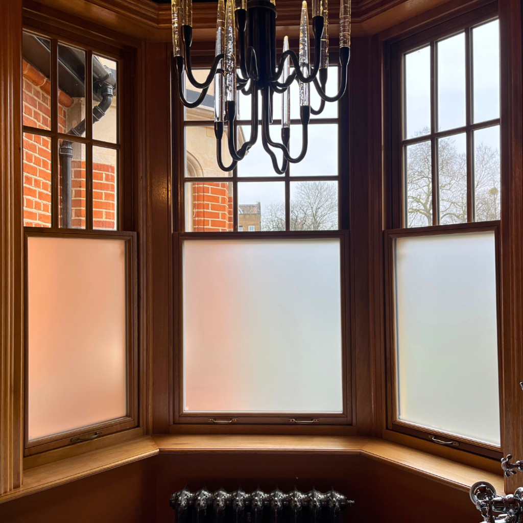 Frosted film applied to an elegant bathroom window for privacy from the street