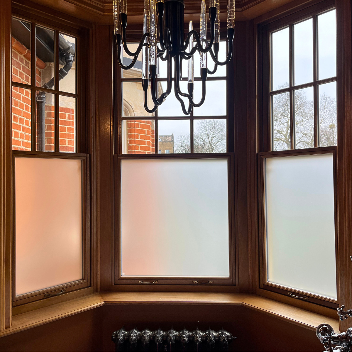Frosted security window film applied to windows, providing full privacy, shatter resistance, and natural light transmission