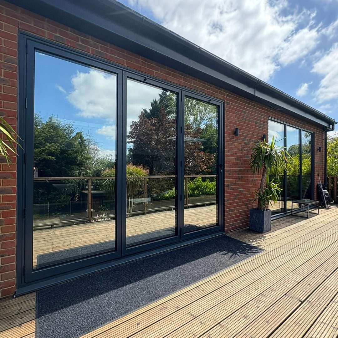 Reflective solar window film applied to bifold doors, representing all window film options including privacy, security, and solar control films