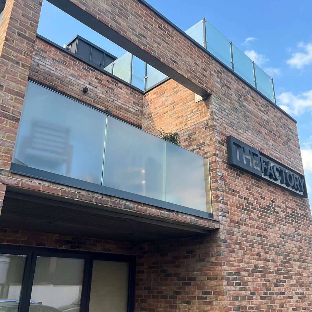 Frosted window film applied to modern glass balcony panels, providing daytime and nighttime privacy while allowing natural light through