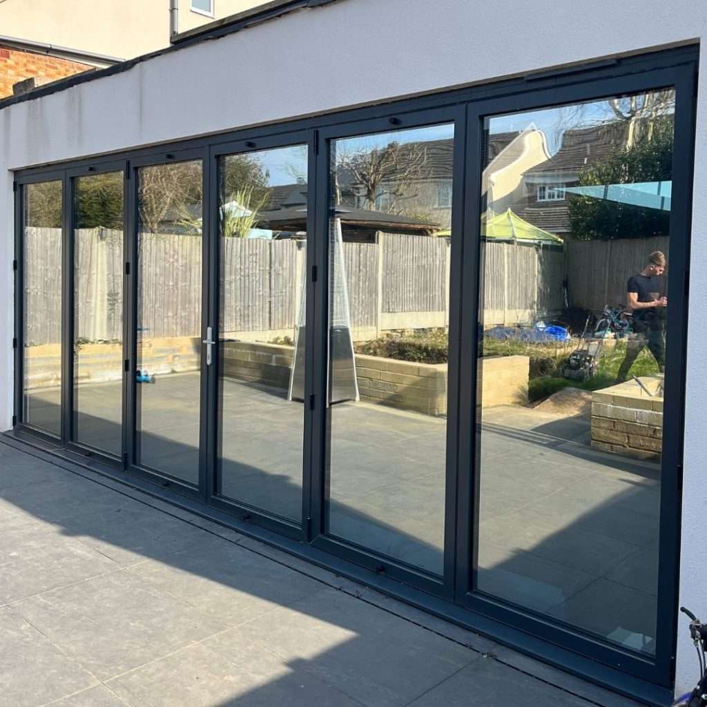 Silver 20 reflective solar film applied to six bifold door panes for complete daytime privacy