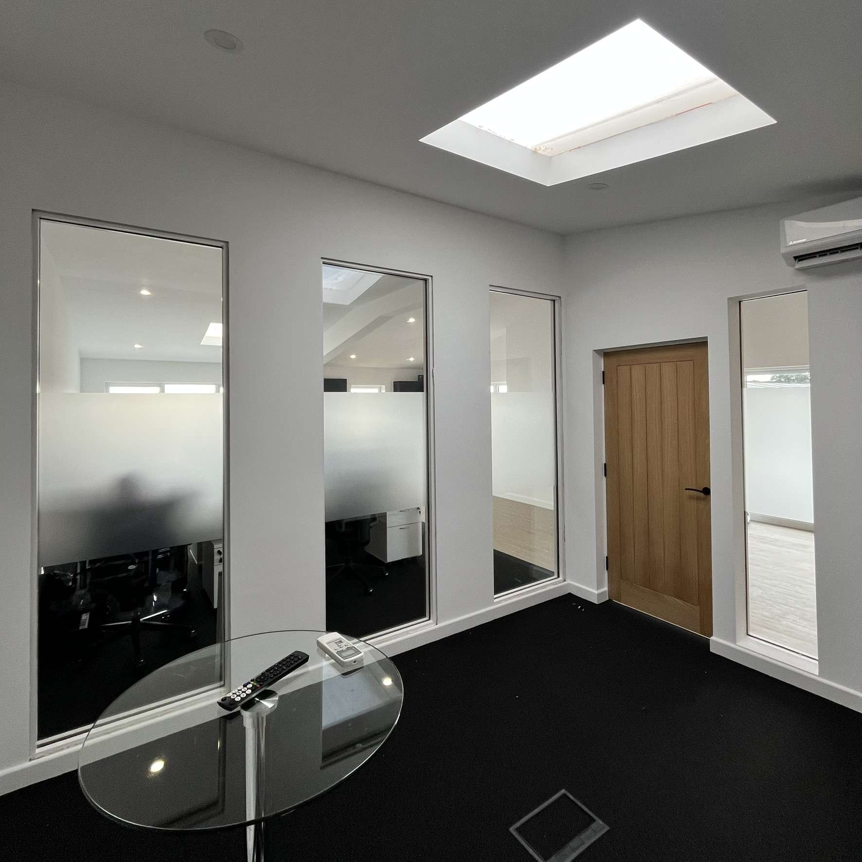 Internal view of a Canterbury office showing a frosted window film band applied across multiple glass panels, providing privacy while maintaining light flow throughout the workspace.