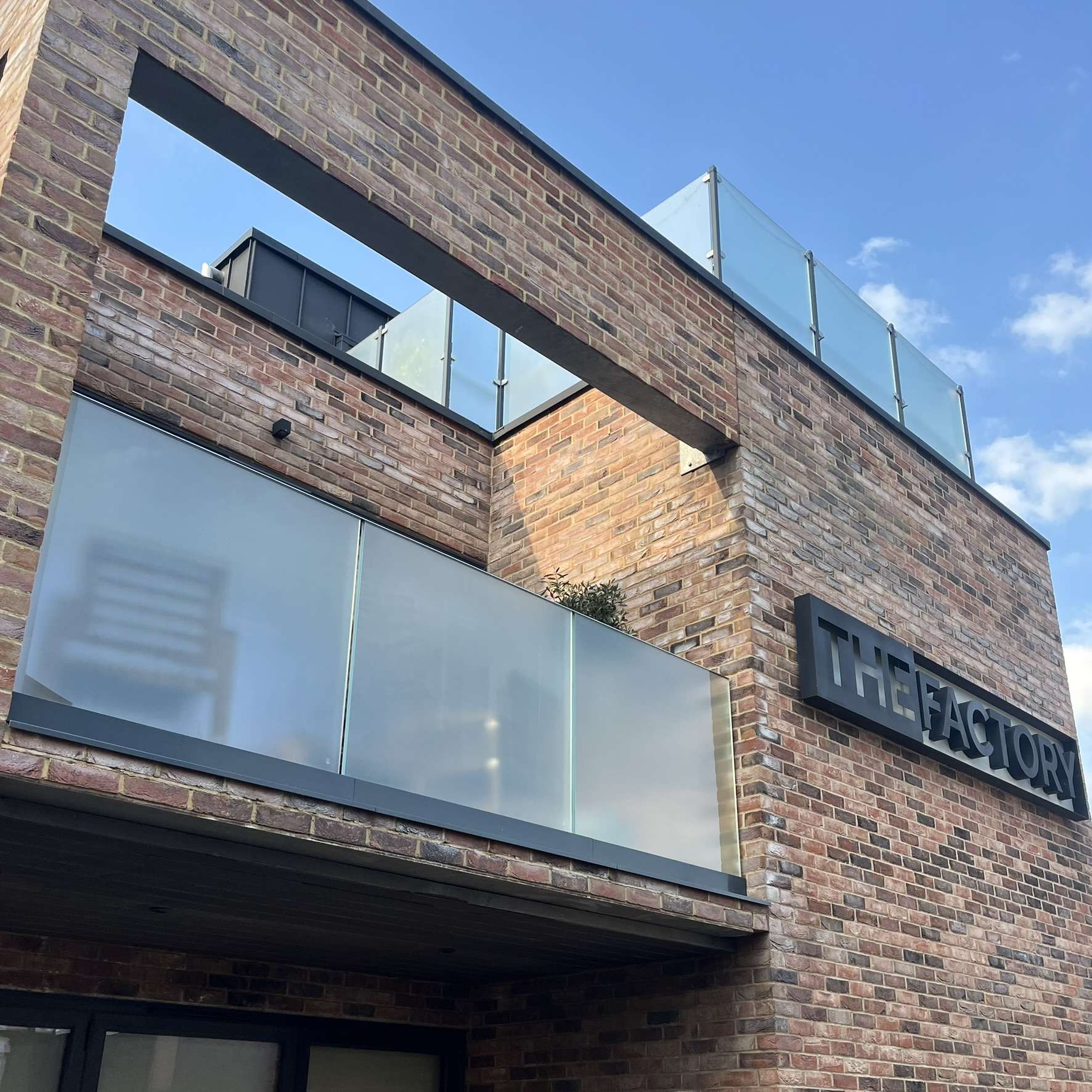 External view of a commercial balcony balustrade in London fitted with frosted window film, providing privacy while maintaining a clean, modern appearance.