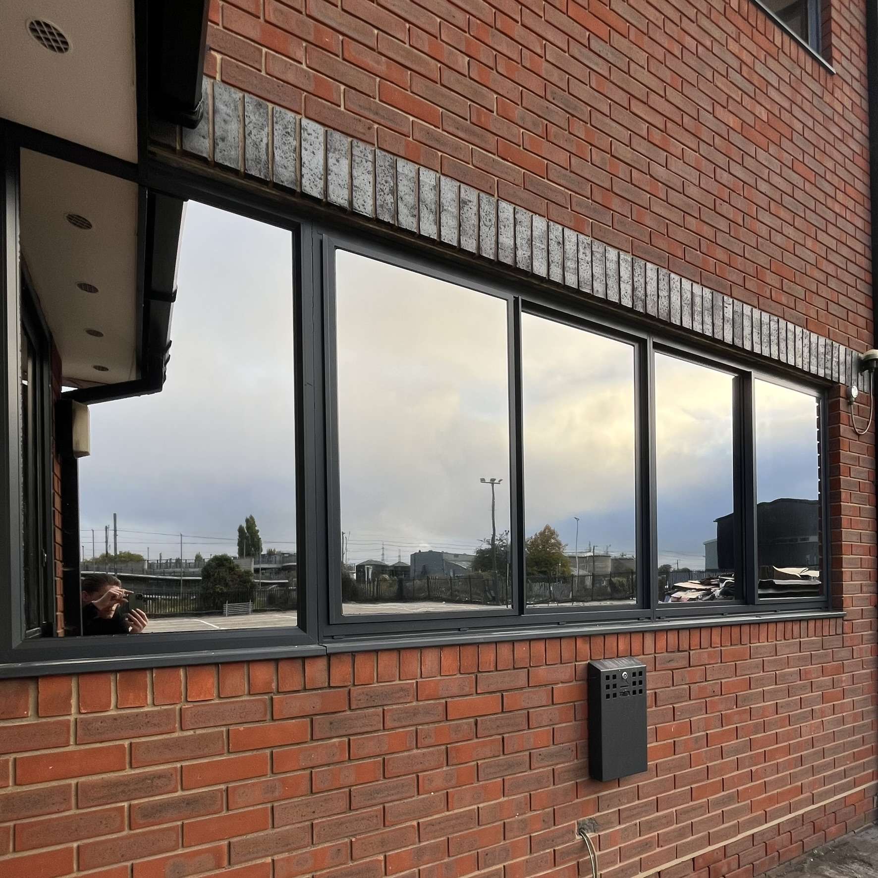Outside view of Silver 20 reflective solar film installed on car dealership office windows in Purfleet for daytime privacy and solar control.