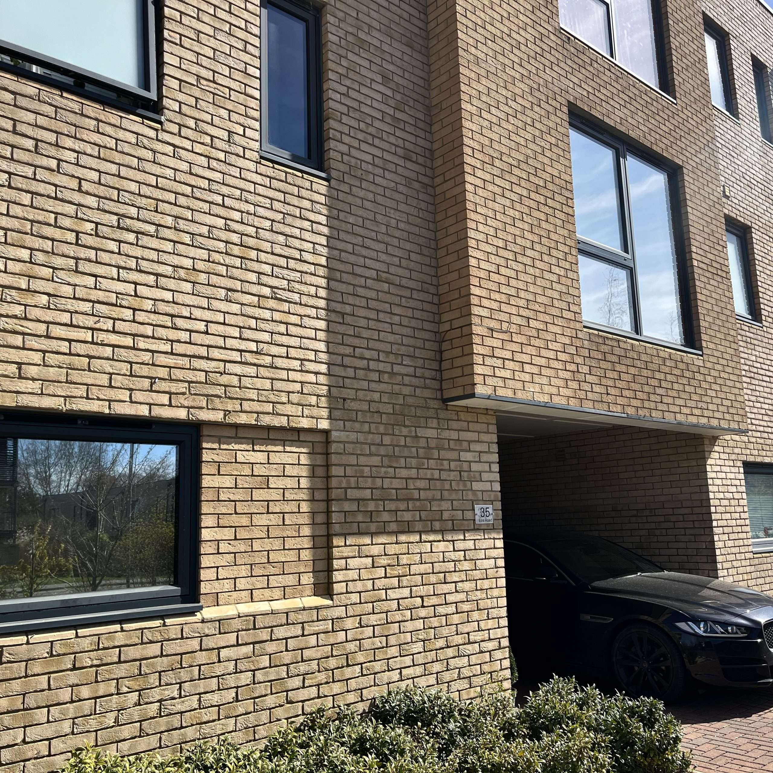 External view of a commercial apartment building in London with windows fitted with Silver 35 reflective solar window film, improving privacy and overall energy efficiency.