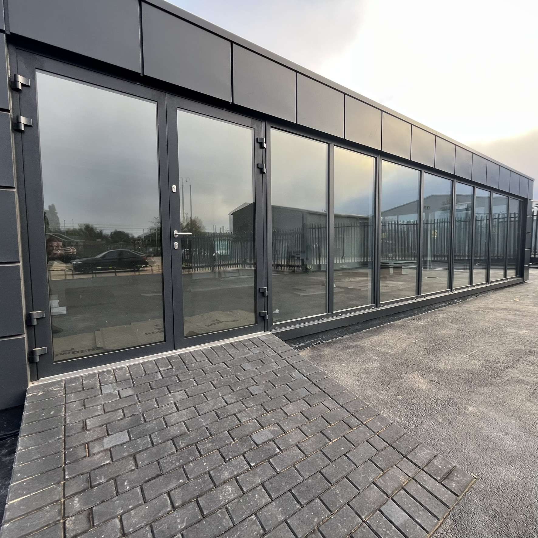 Outside view of Silver 50 reflective solar film installed on a car dealership unit in Purfleet to reduce glare, heat build up, and UV exposure.