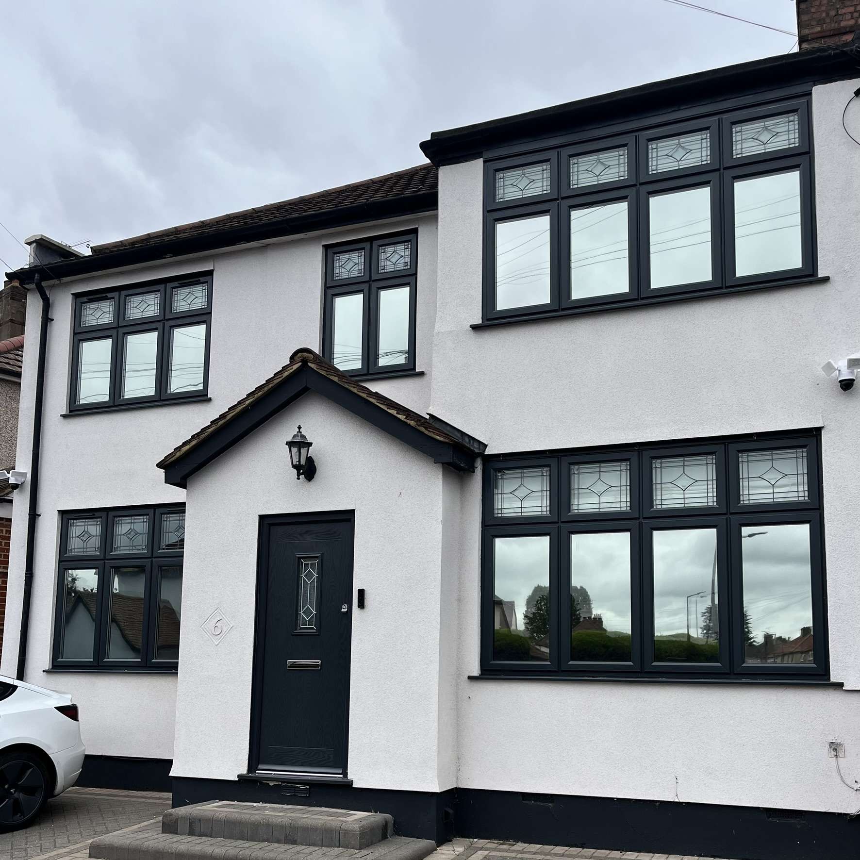 Silver 20 reflective solar film applied to the front of a house in Barnet for daytime privacy and UV protection.