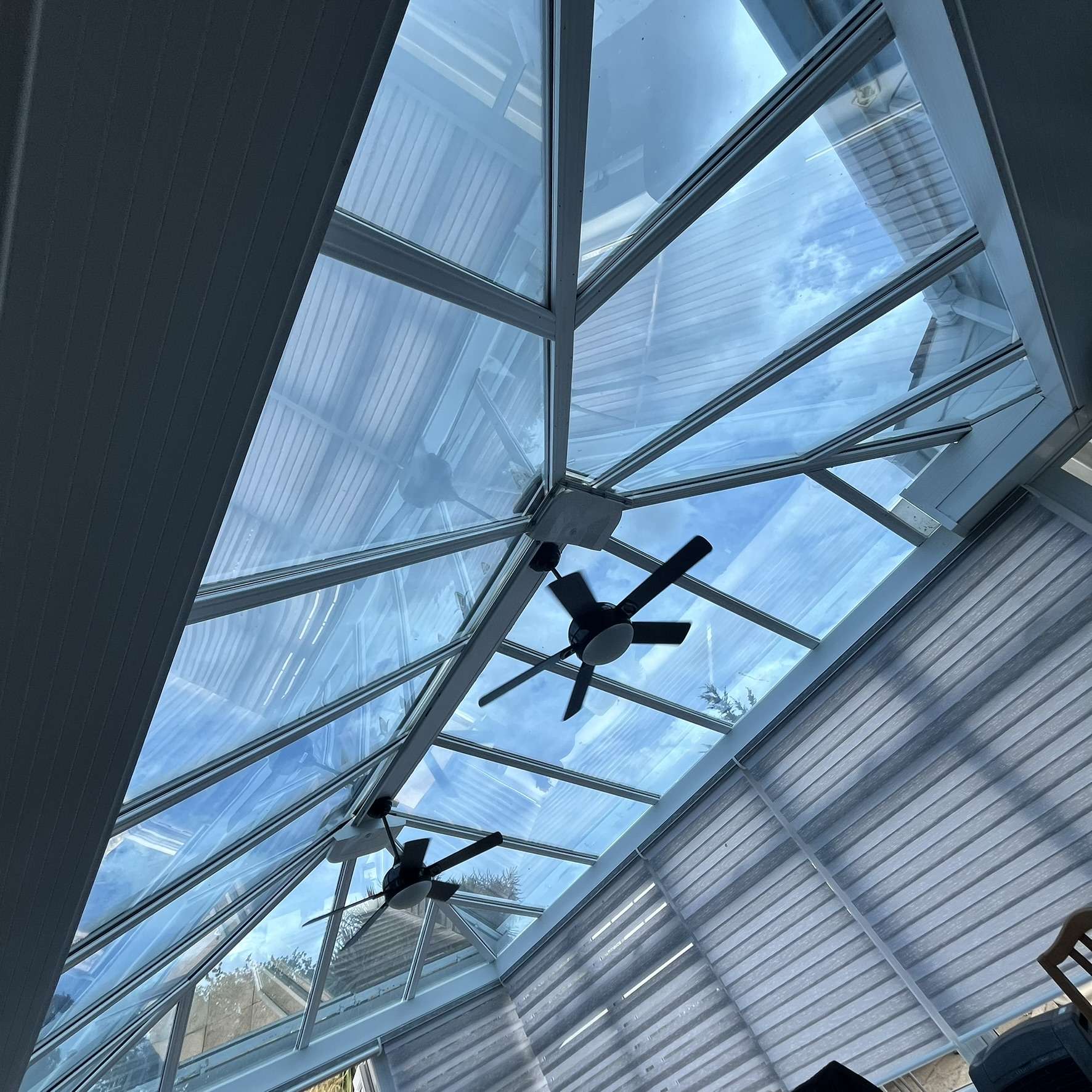Internal view of a Brentwood conservatory roof fitted with Silver 20 reflective solar window film, reducing glare and heat while helping protect interiors from UV damage.