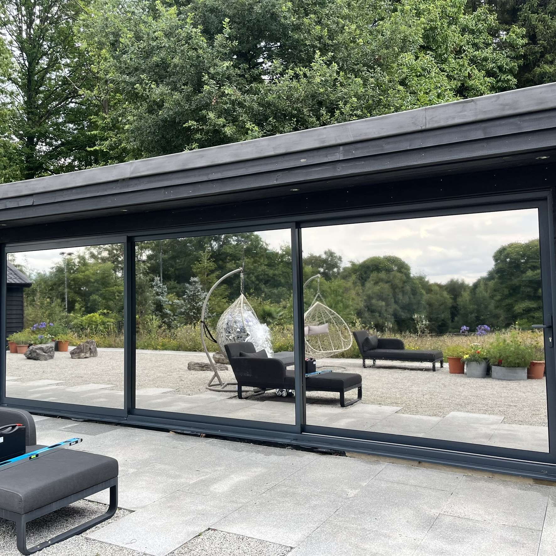 Close-up external view of sliding doors in Chigwell with Silver 20 reflective solar window film installed, showing privacy benefits and UV protection.