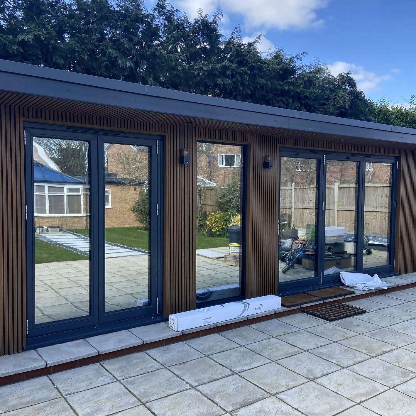 External view of a garden cabin in Colchester fitted with Silver 20 reflective solar window film, providing privacy from neighbouring properties while creating a more comfortable interior space.