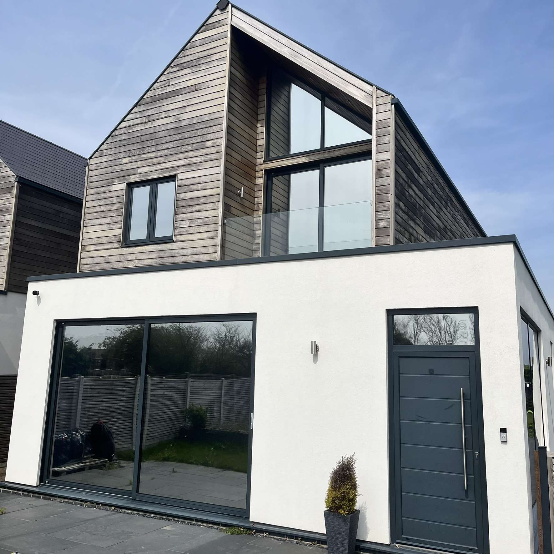 External view of a modern residential property in Colchester fitted with Silver 20 reflective solar window film, enhancing privacy, solar protection, and a sleek contemporary appearance.