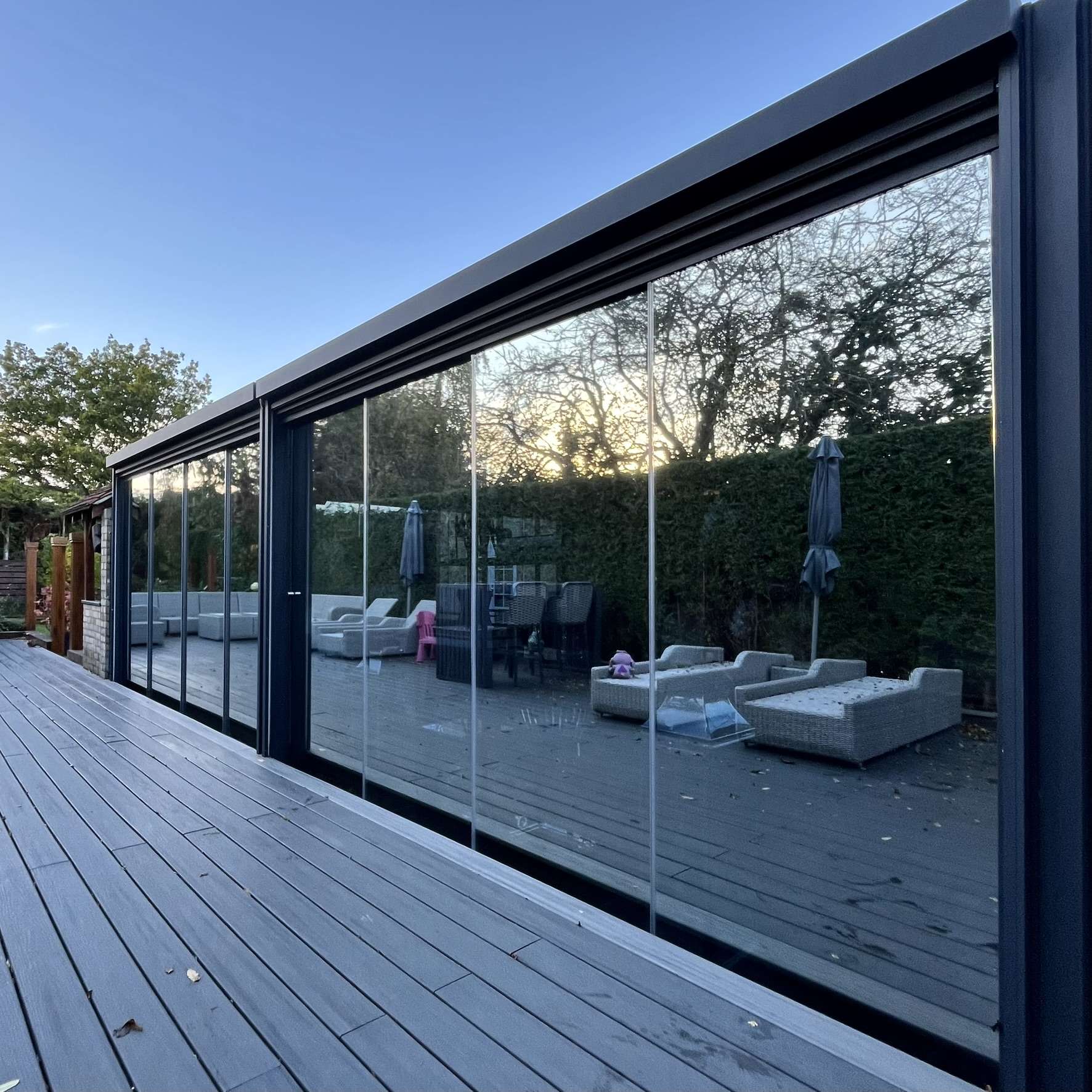 Front view of Silver 20 reflective solar film installed on a residential pergola in Colchester to provide full daytime privacy and UV protection for high end interiors.