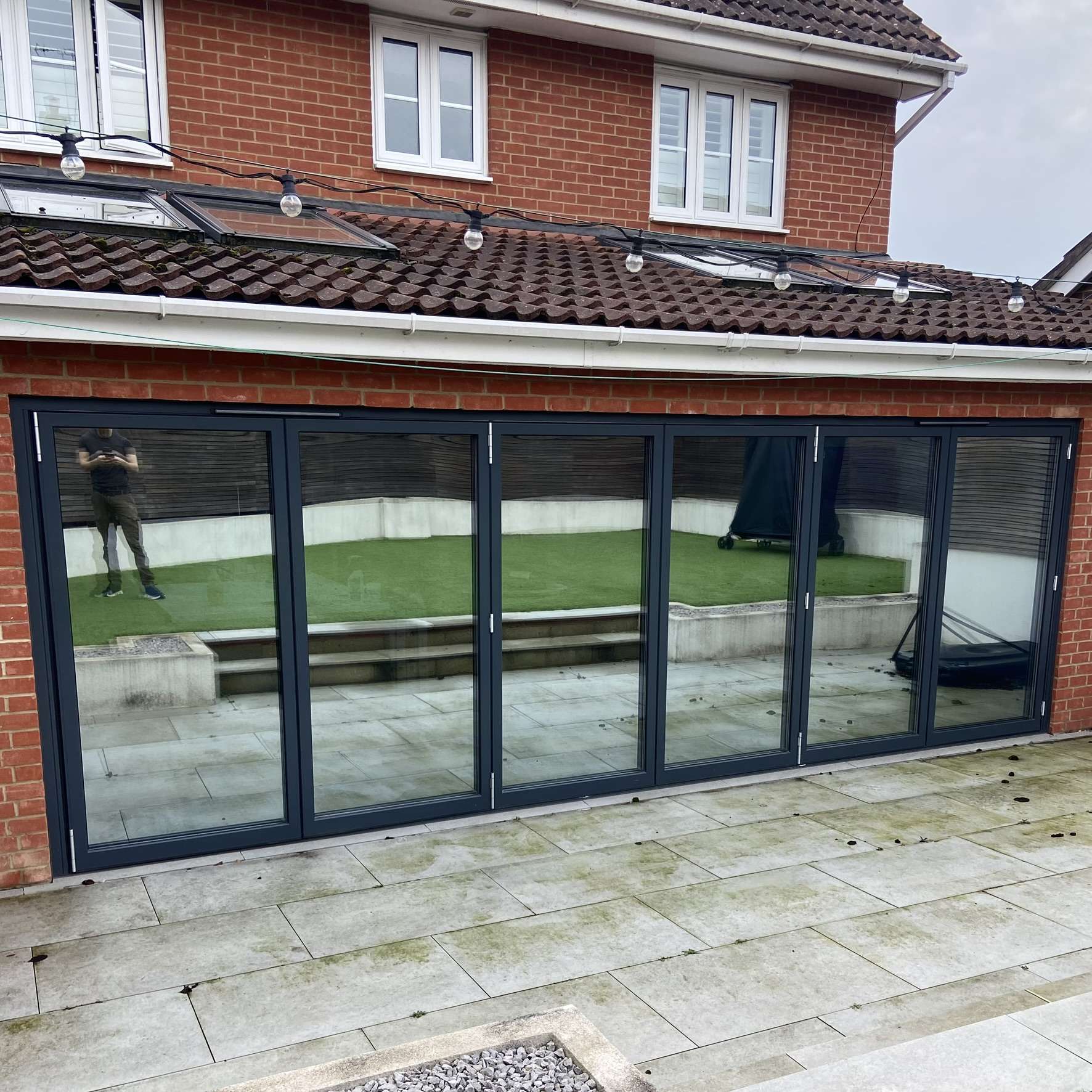 External rear view of a residential property in Essex with bifold doors fitted with Silver 20 reflective solar window film, providing full daytime privacy.