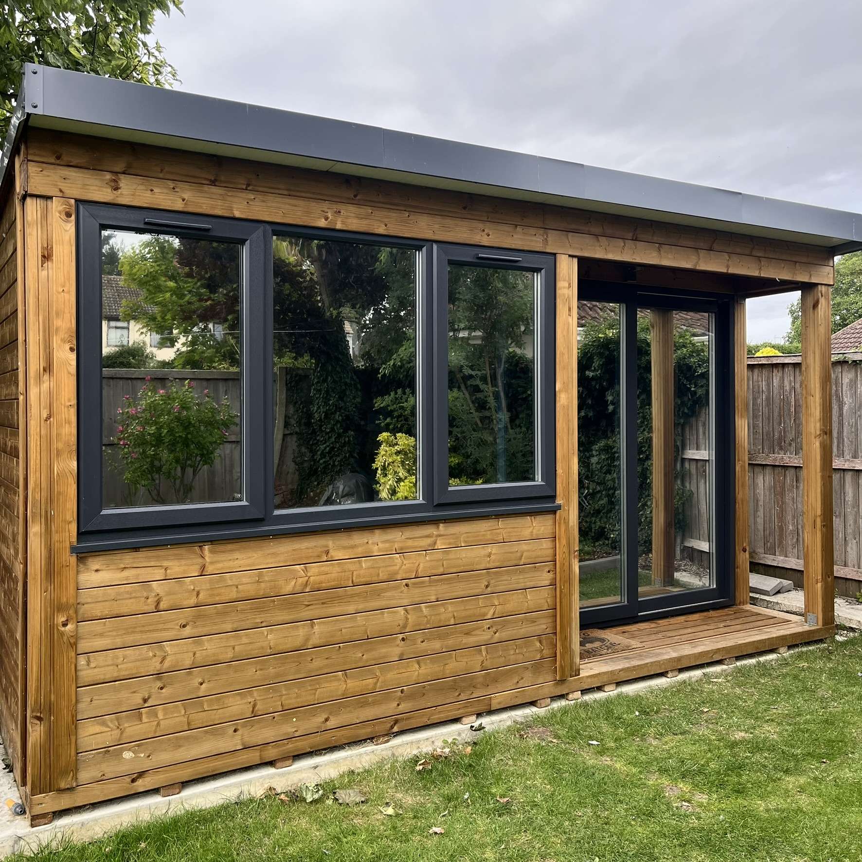 External view of a residential cabin in Essex fitted with Silver 20 reflective solar window film, providing privacy from overlooking neighbours while helping to control solar heat.