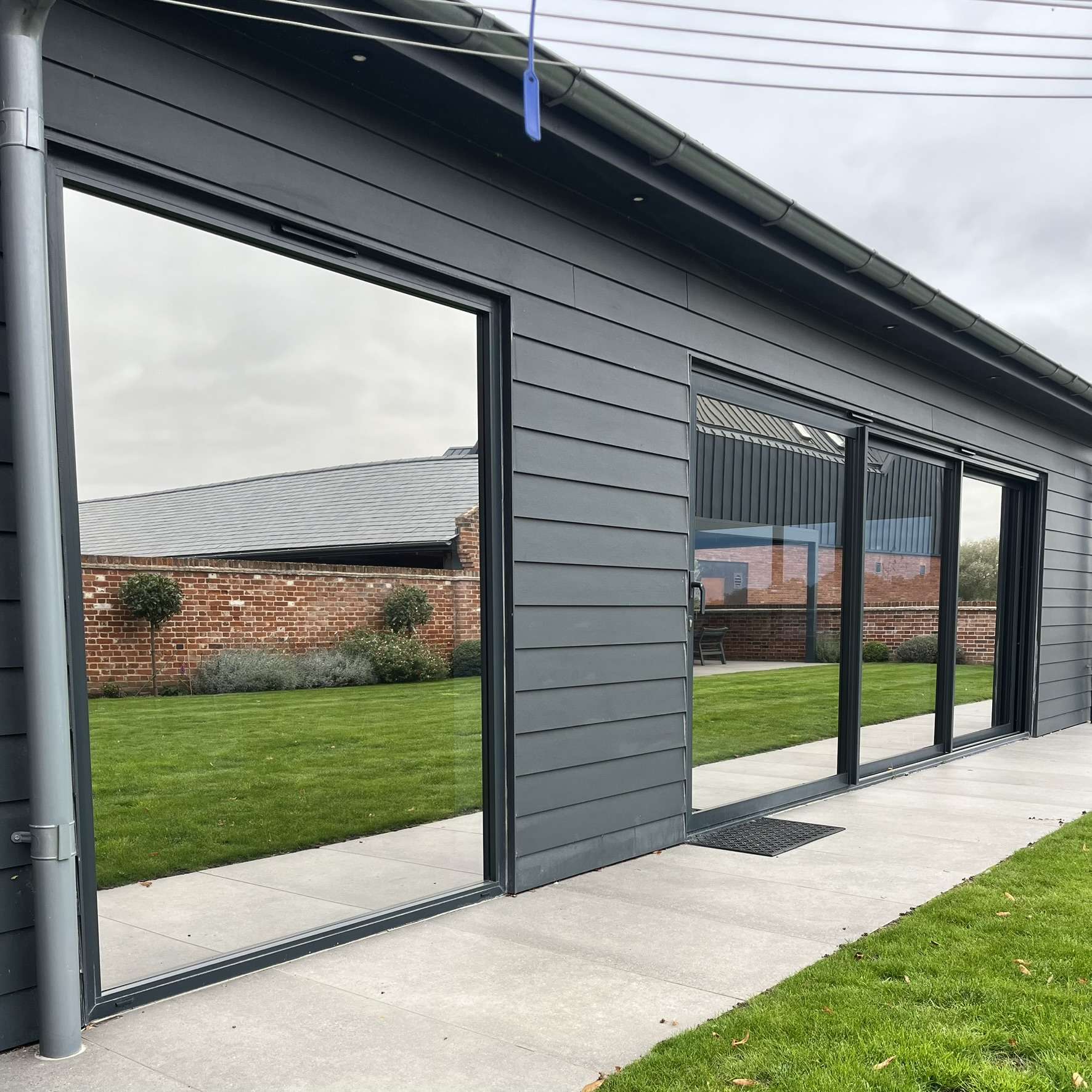 Close-up external view of sliding doors on an Ipswich home fitted with Silver 20 reflective solar window film, highlighting privacy and solar control benefits.