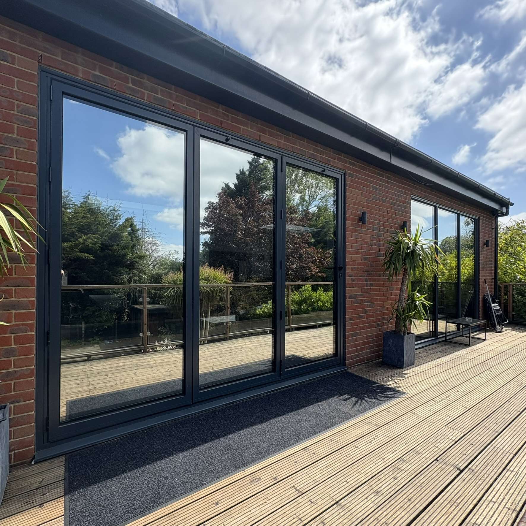 External view of a residential garden cabin in Kent fitted with Silver 20 reflective solar window film, improving privacy while reducing glare.