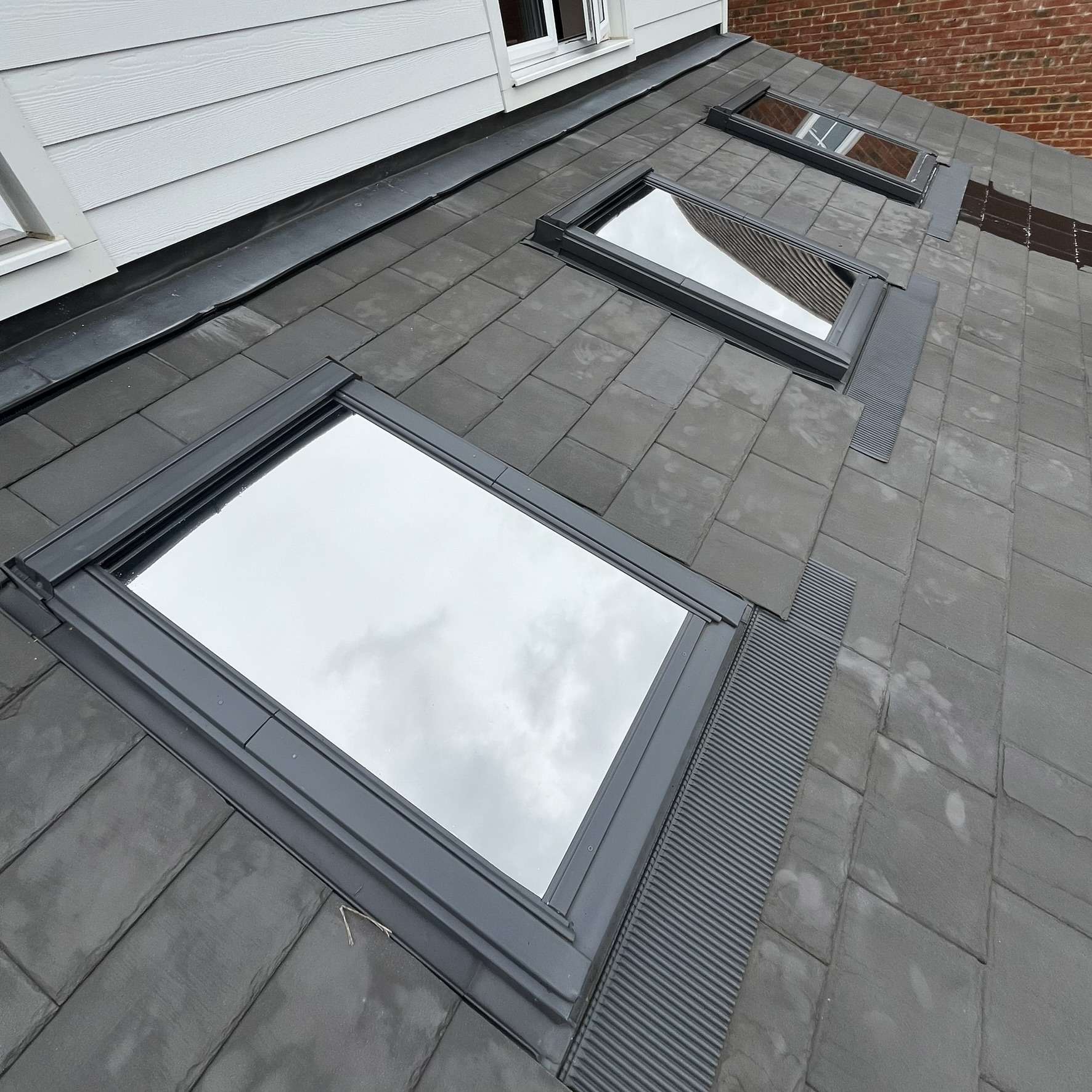 External Silver 20 reflective solar film installed on three velux windows in Norfolk, reducing glare and heat while blocking damaging UV rays from entering the property.