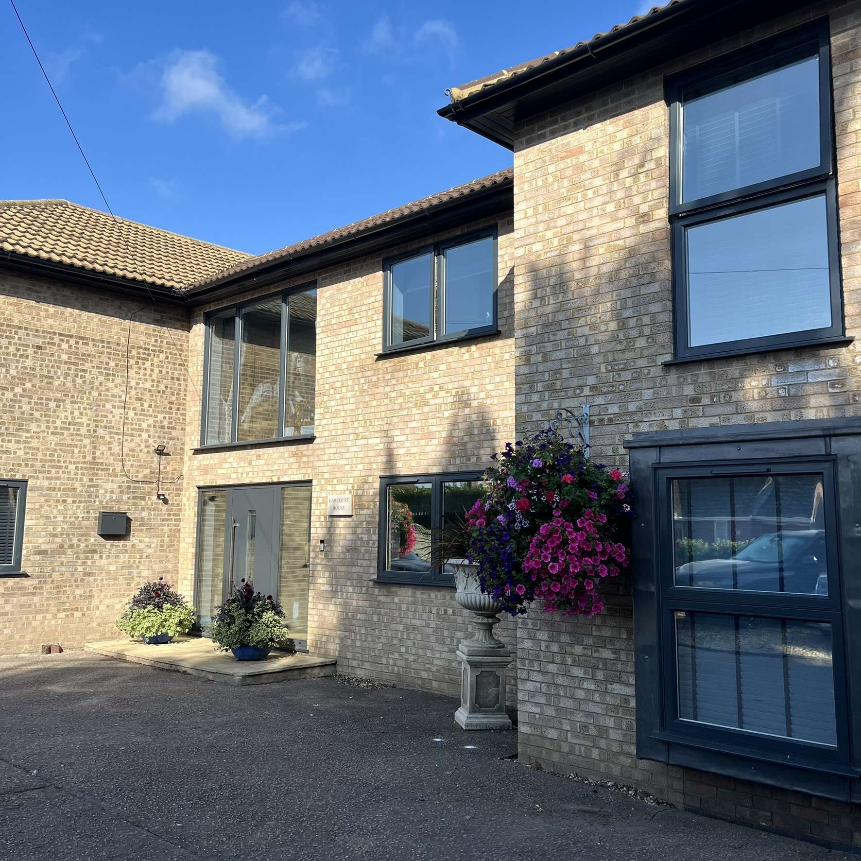 External front view of a large residential property in Ipswich fitted with Silver 35 reflective solar window film, providing full daytime privacy along with heat and UV protection.