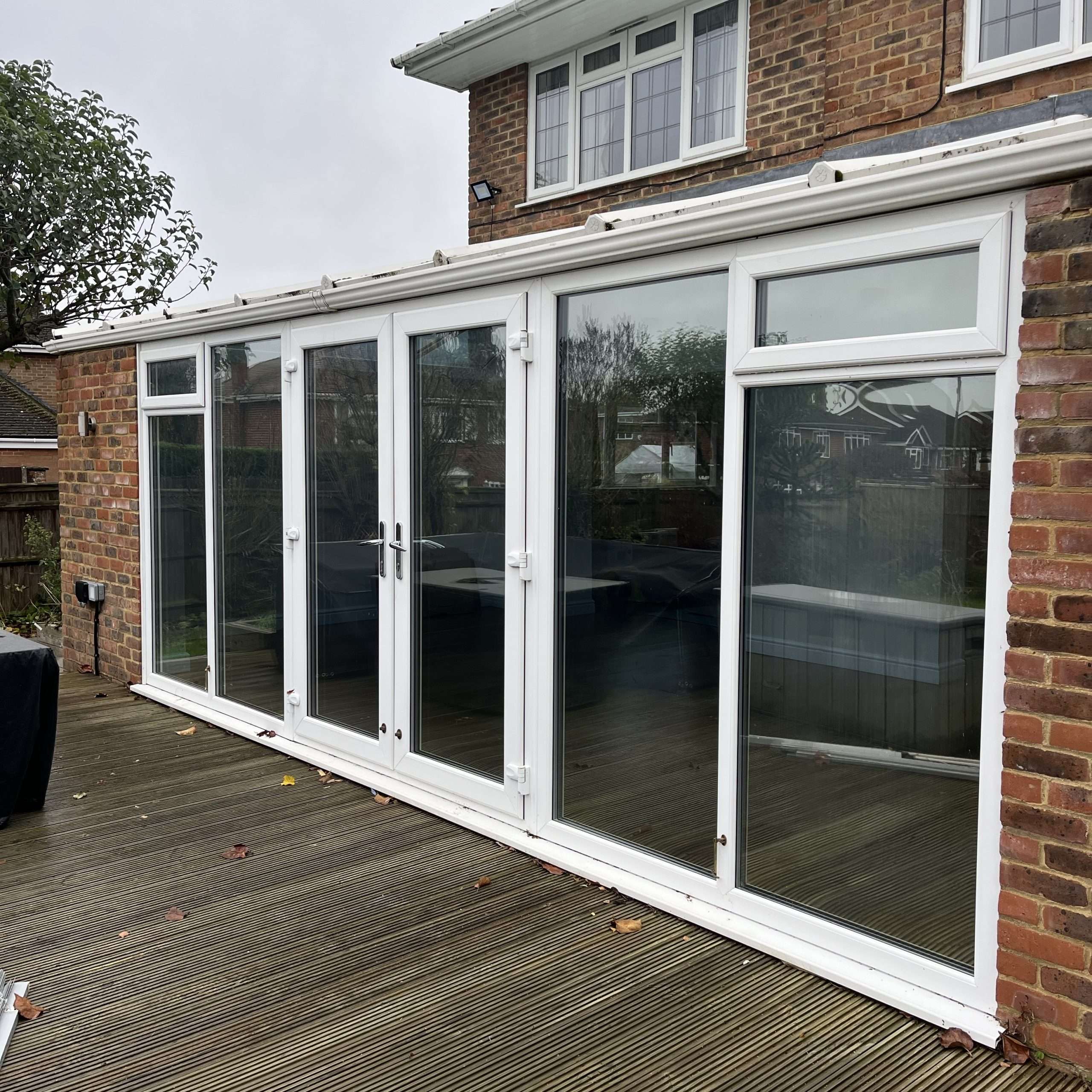 Outside view of Silver 50 reflective solar film installed on conservatory doors and side windows in High Wycombe for year round solar control and glare reduction.