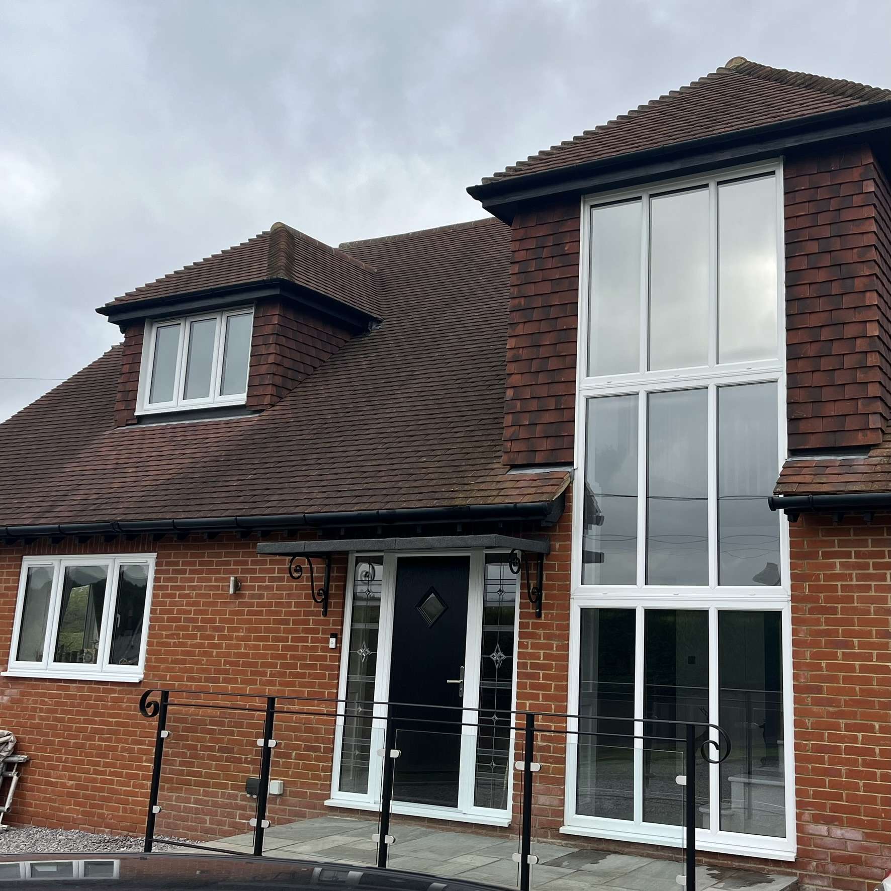 Outside view of Silver 50 reflective solar film installed on the front windows of a residential property in Kent for UV protection and improved heat control.
