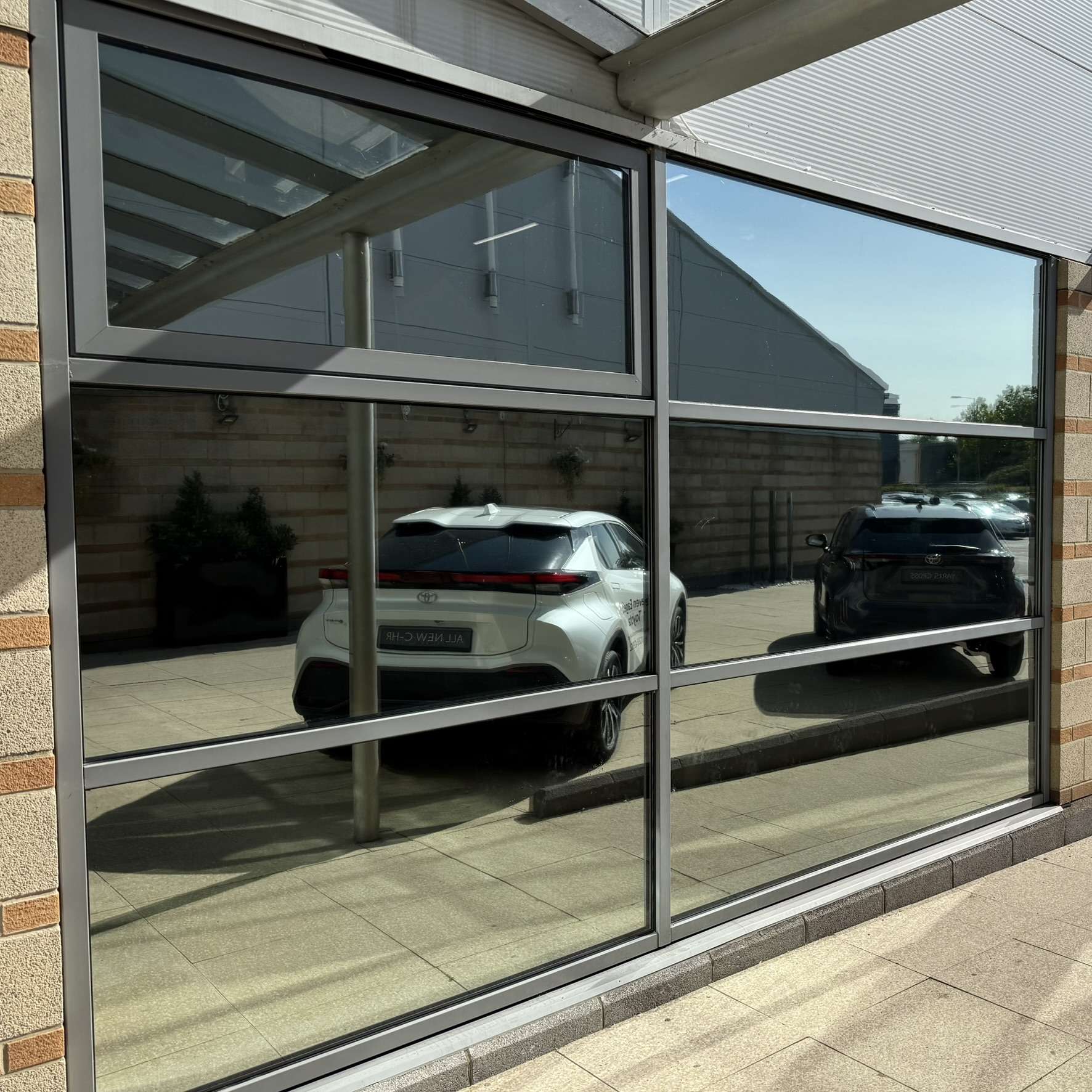 External view of the entrance glazing at David Lloyd in Basildon fitted with Silver 20 reflective solar window film, improving privacy for gym users while helping reduce heat and UV exposure.