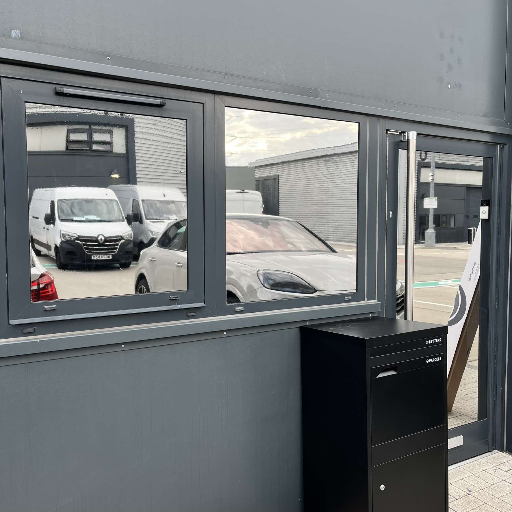 External view of a warehouse in Essex fitted with Silver 20 reflective solar window film, improving security by limiting visibility into stock areas.