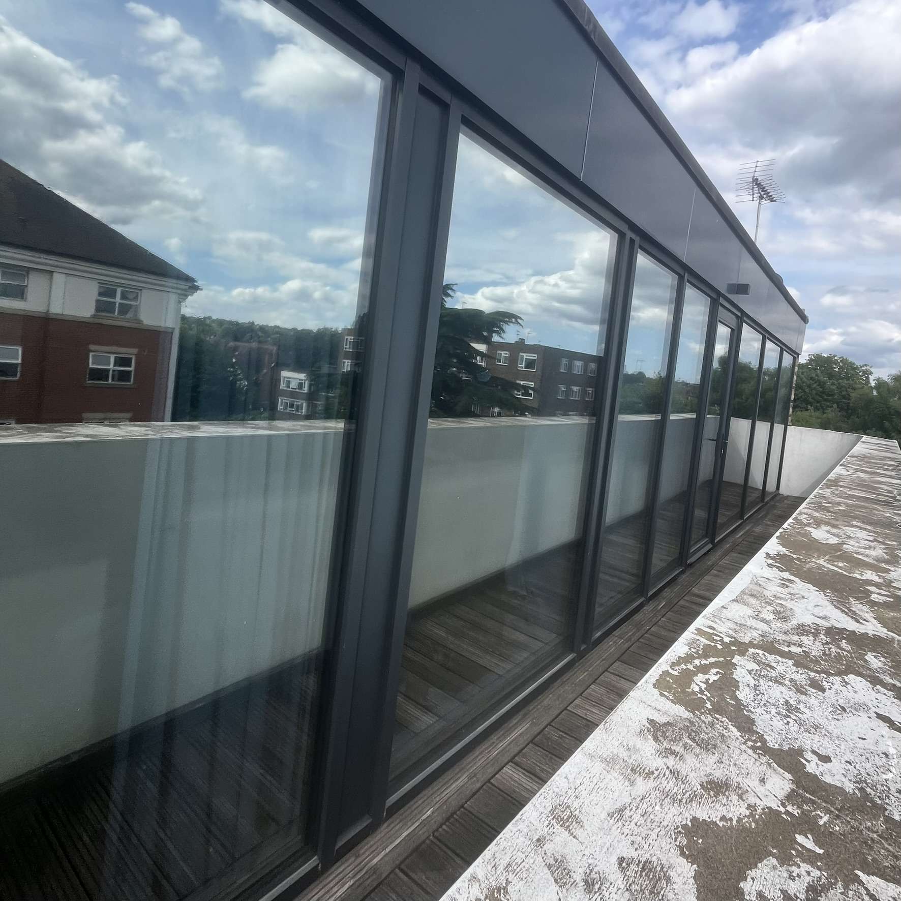 External view of a commercial apartment building in London with Silver 20 reflective solar window film applied across the glazing, improving privacy and energy efficiency.