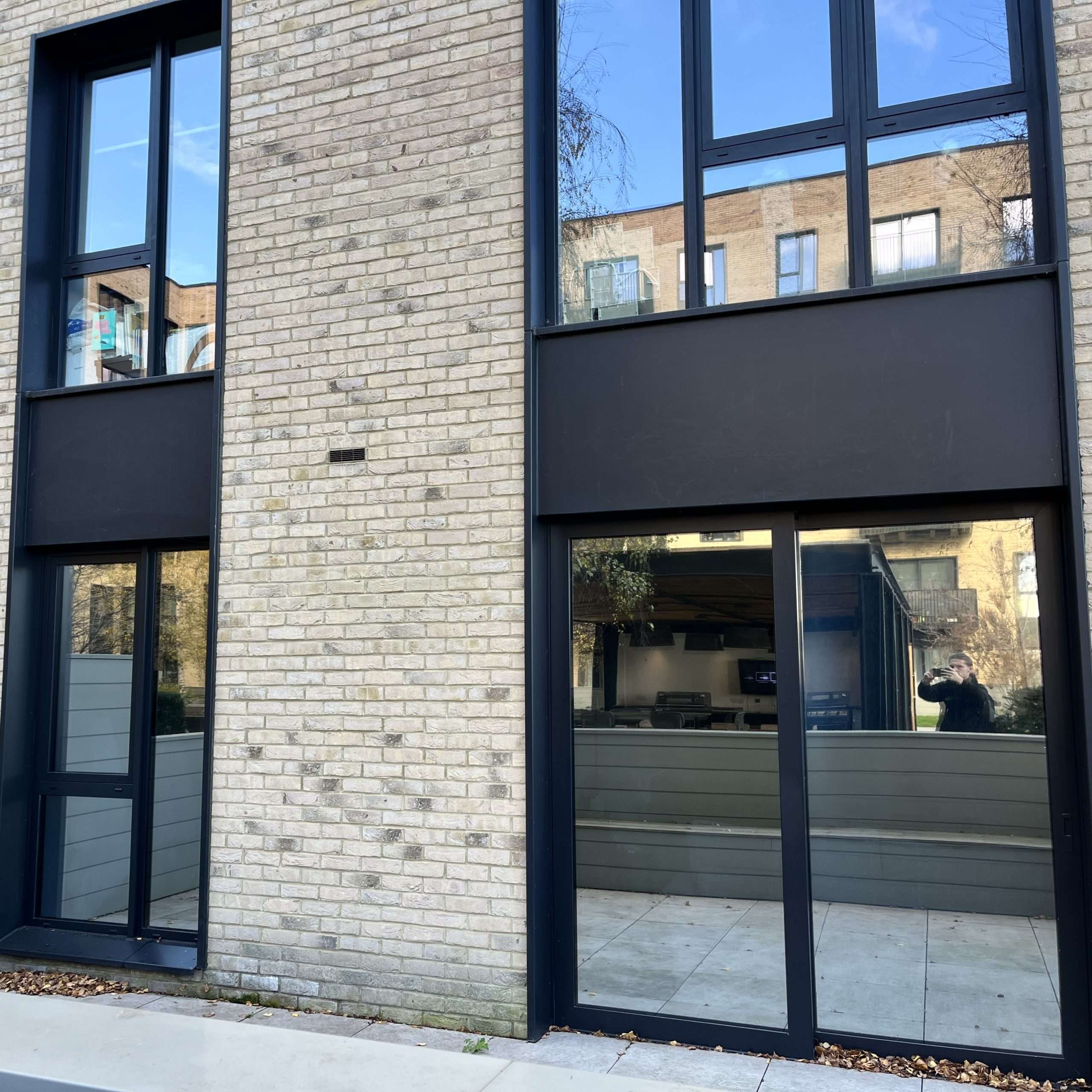 External view of a block of apartments in Norwich fitted with Silver 20 reflective solar window film, enhancing privacy while supporting solar heat control.