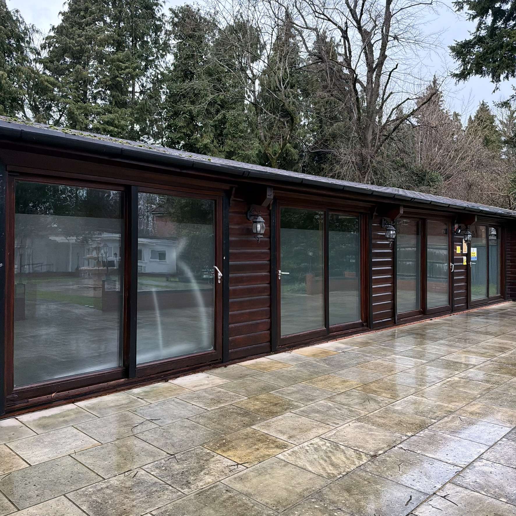 External view of a High Wycombe cabin with a frosted window film band applied to the glazing, improving privacy while maintaining light entry through the upper glass.