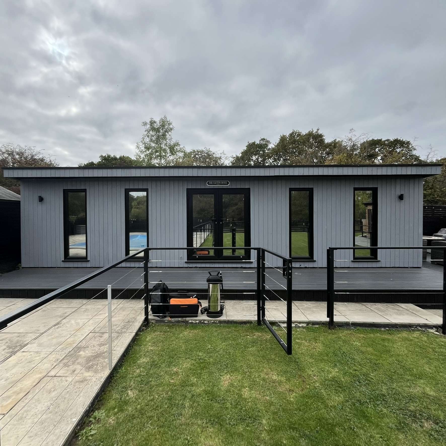External view of a garden cabin in Benfleet fitted with Silver 20 reflective solar window film, creating a more comfortable space with added solar protection.