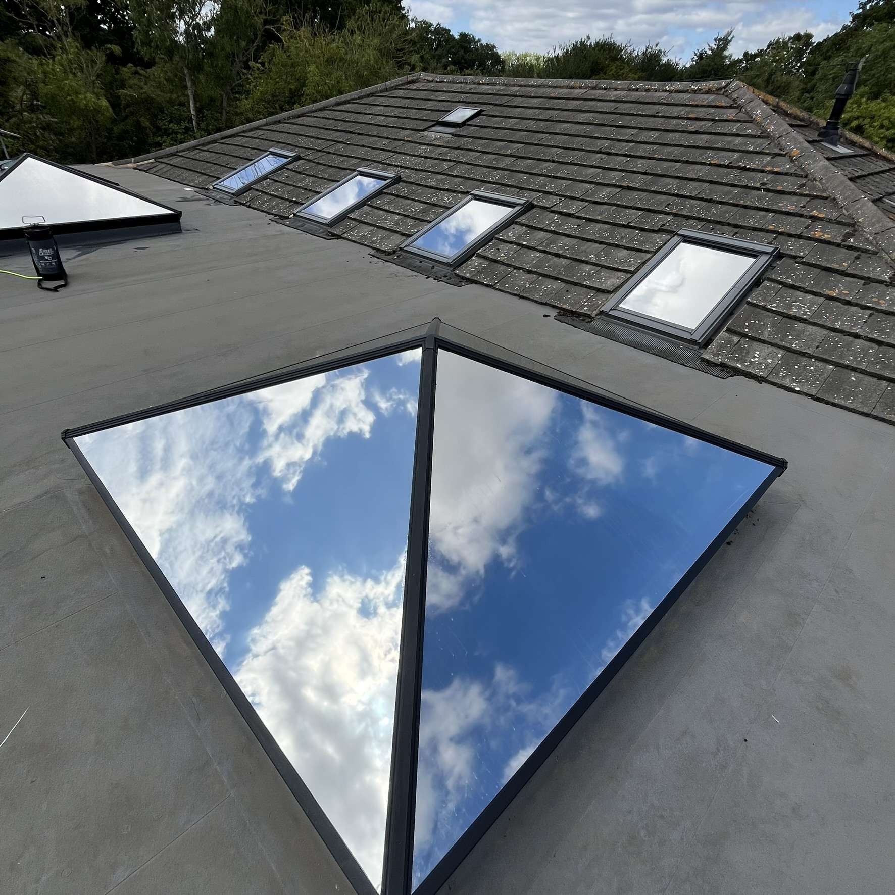 External view of roof skylights and Velux windows on a Benfleet property fitted with external Silver 20 reflective solar window film, helping control heat and block UV rays.