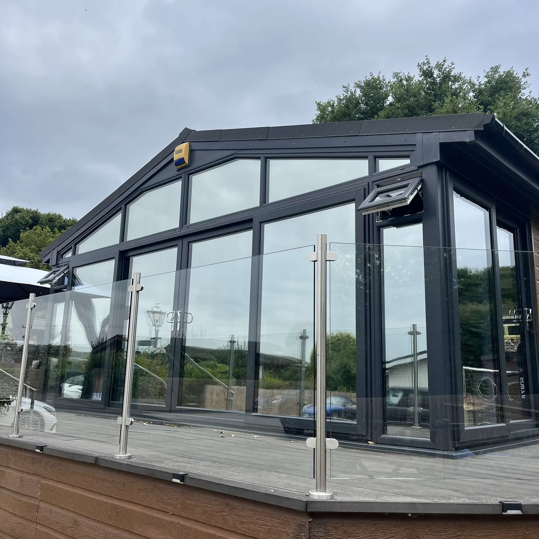 External angled view of a Bewdley chalet with Silver 20 reflective solar window film installed, providing privacy and helping control glare and solar heat.