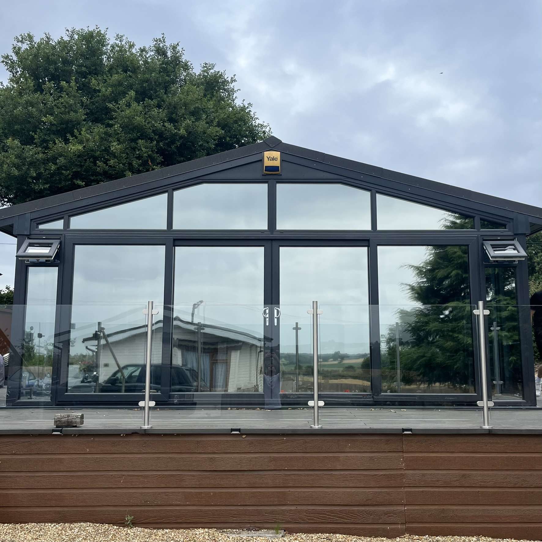 External straight-on view of a chalet in Bewdley fitted with Silver 20 reflective solar window film, improving privacy from nearby chalets while reducing glare and heat.