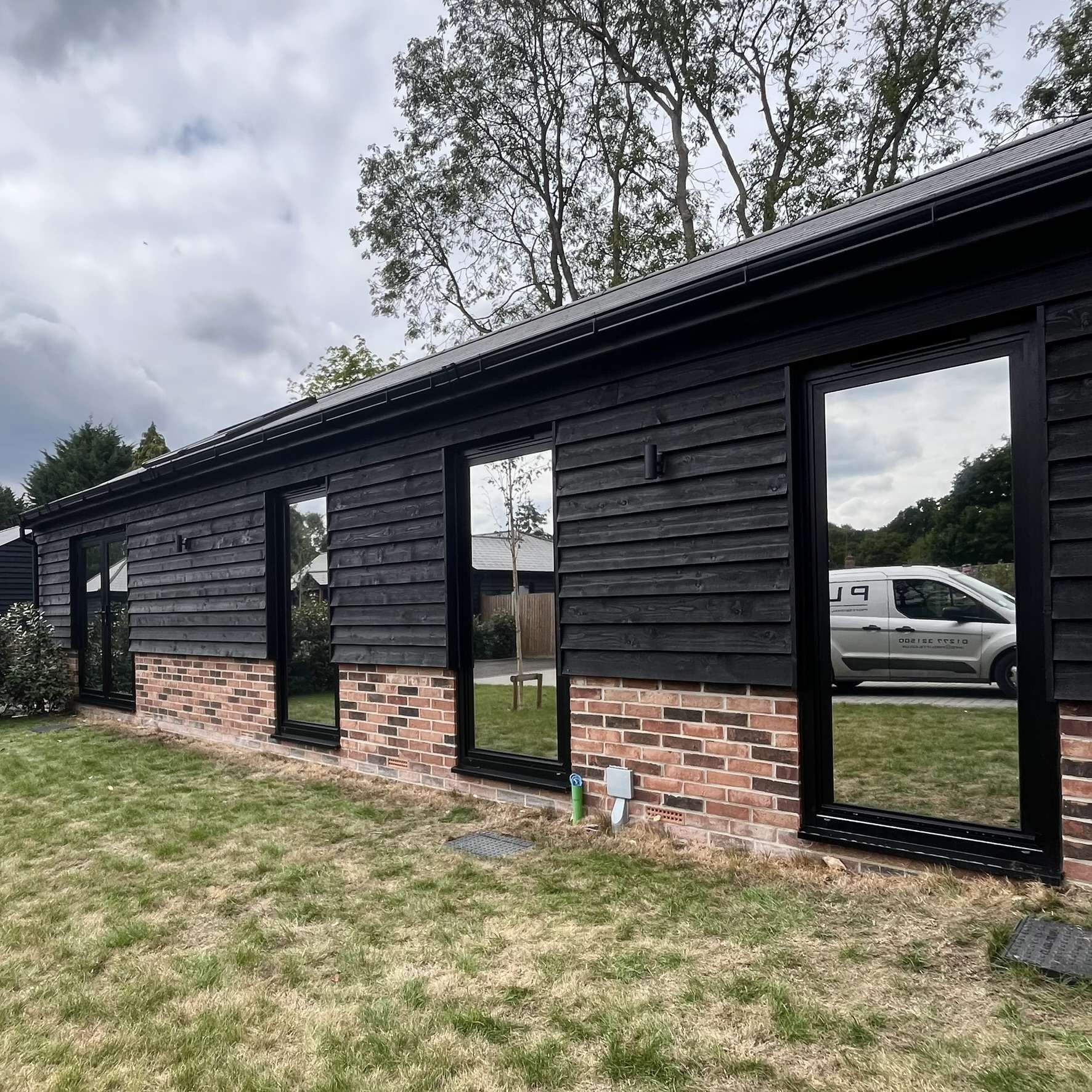 External view of a barn in Brentwood with all glazing fitted with Silver 20 reflective solar window film, helping reduce glare and control solar heat.