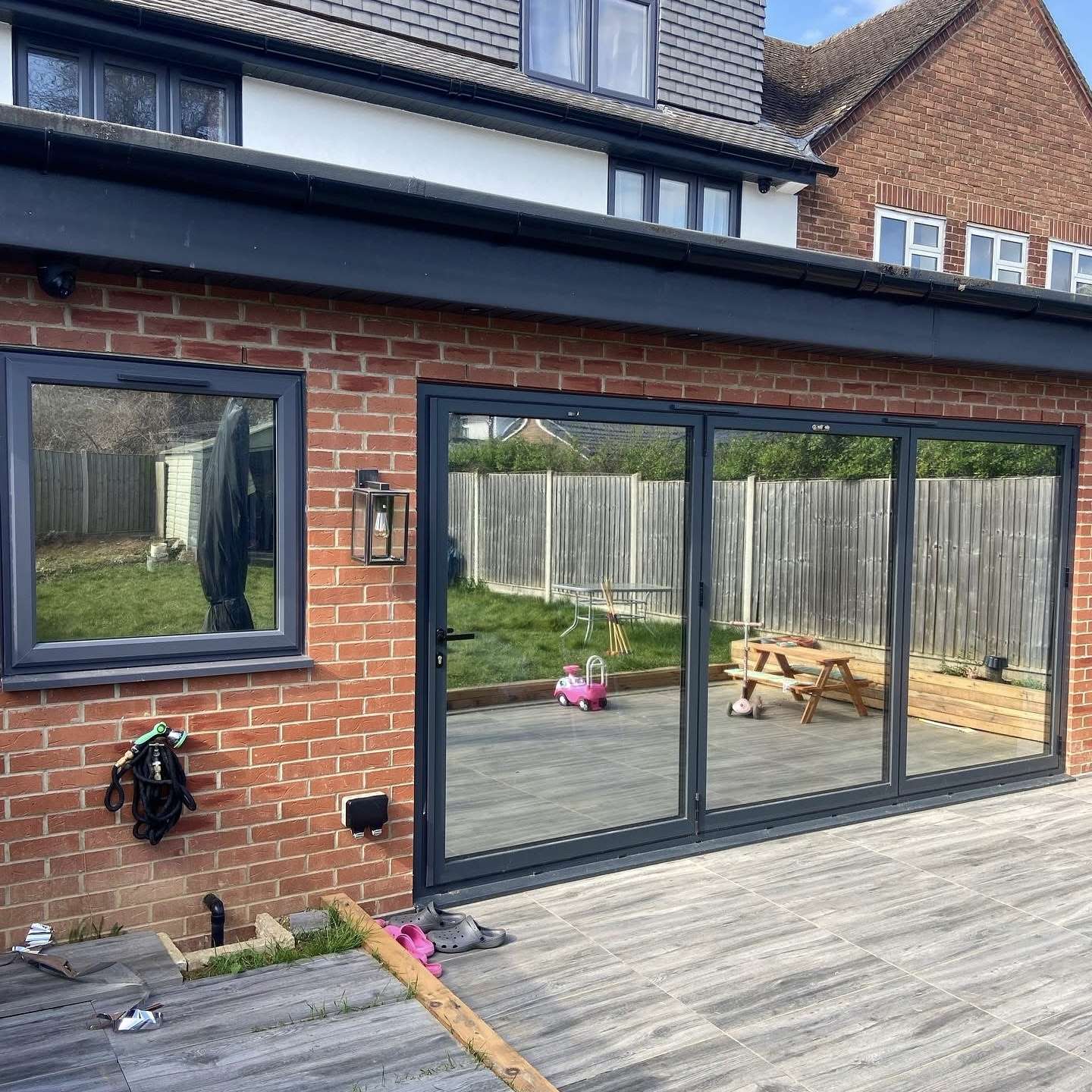 External rear view of a home extension in Crawley fitted with Silver 20 reflective solar window film, improving privacy from overlooking neighbours while reducing glare.