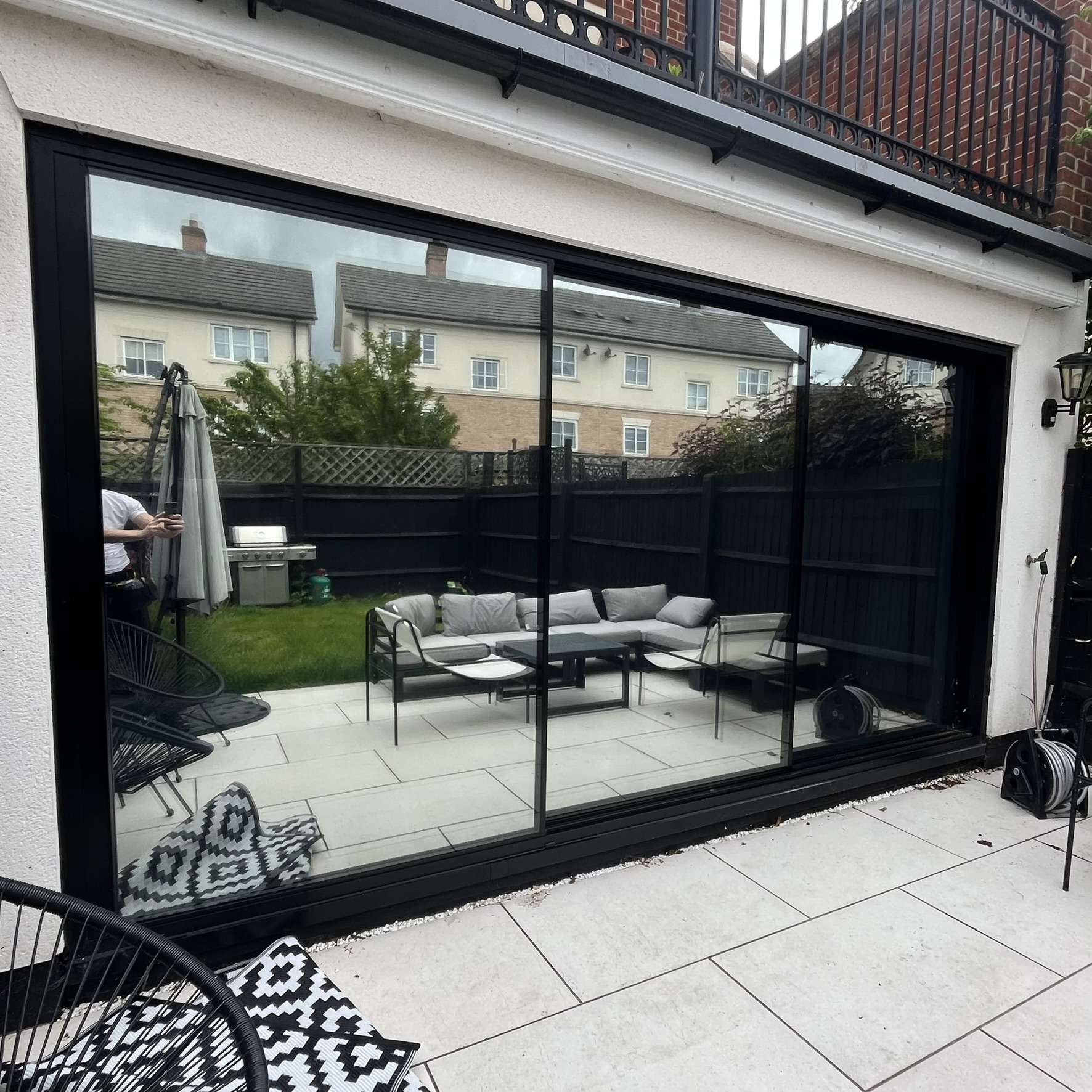 External view of three large sliding doors in East London fitted with Silver 20 reflective solar window film, improving privacy from neighbours while reducing glare.