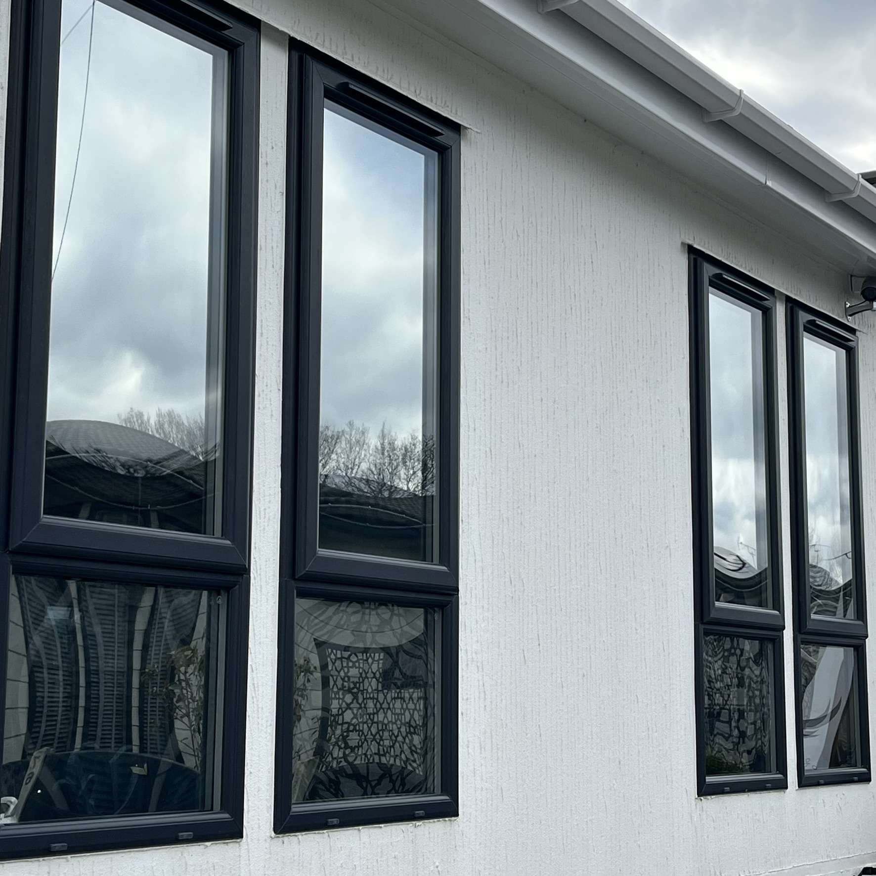 External view of chalet windows in Epping fitted with Silver 20 reflective solar window film, providing privacy from surrounding properties while protecting interiors from UV exposure.