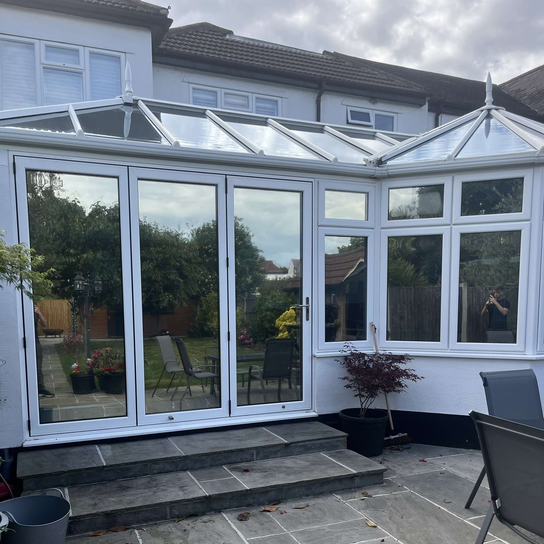 External rear view of a conservatory in Essex with internal Silver 20 reflective solar window film applied to the vertical glazing, helping control heat and glare while reducing UV exposure.