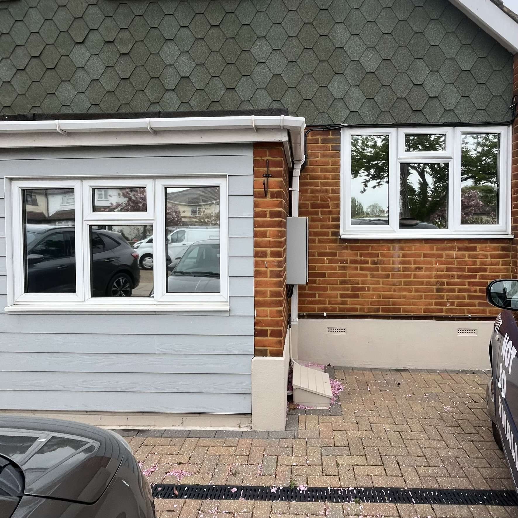 External front view of a property in Harlow fitted with Silver 20 reflective solar window film, improving privacy from people walking past on the path.
