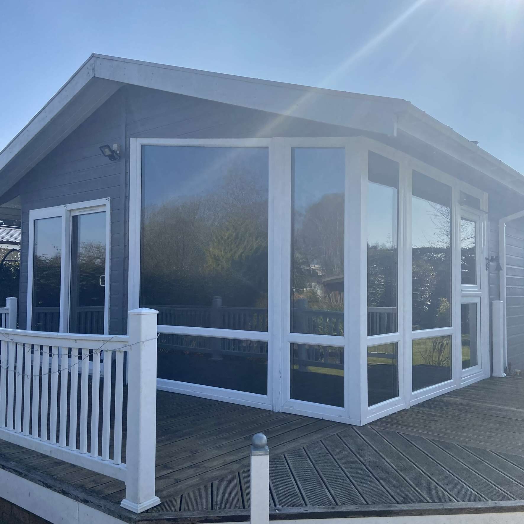 External view of a chalet in Hertford fitted with Silver 20 reflective solar window film, helping reduce glare in bright conditions while improving privacy.