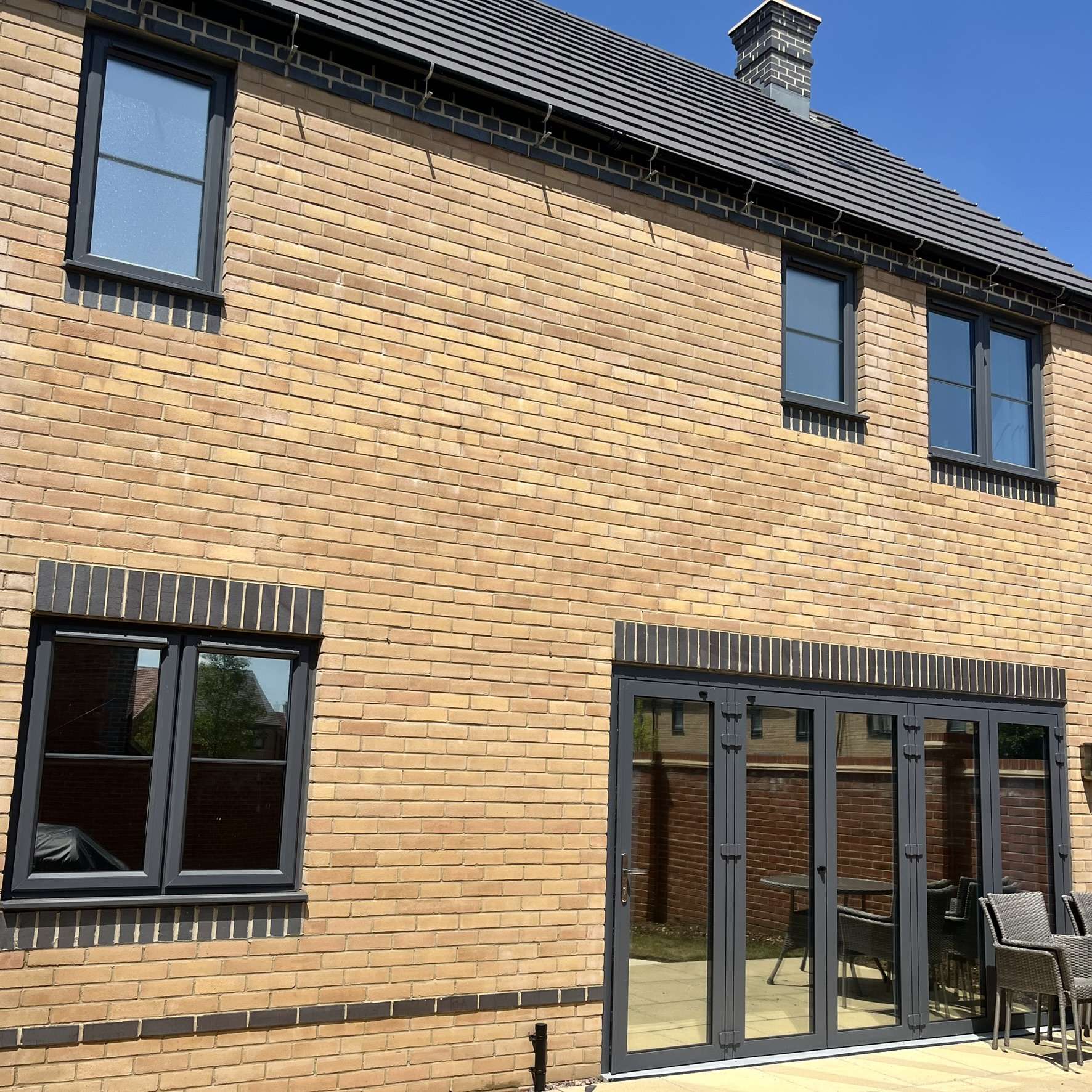 External rear view of a residential property in Milton Keynes fitted with Silver 20 reflective solar window film, improving privacy and solar control.
