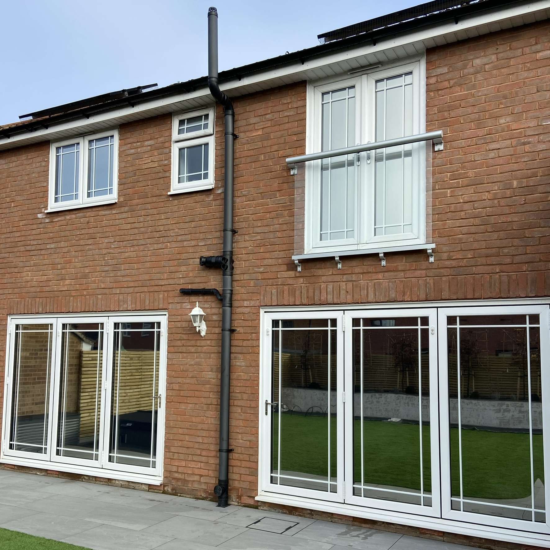 External rear view of a residential property in Orsett fitted with Silver 20 reflective solar window film, improving privacy while helping control solar heat.