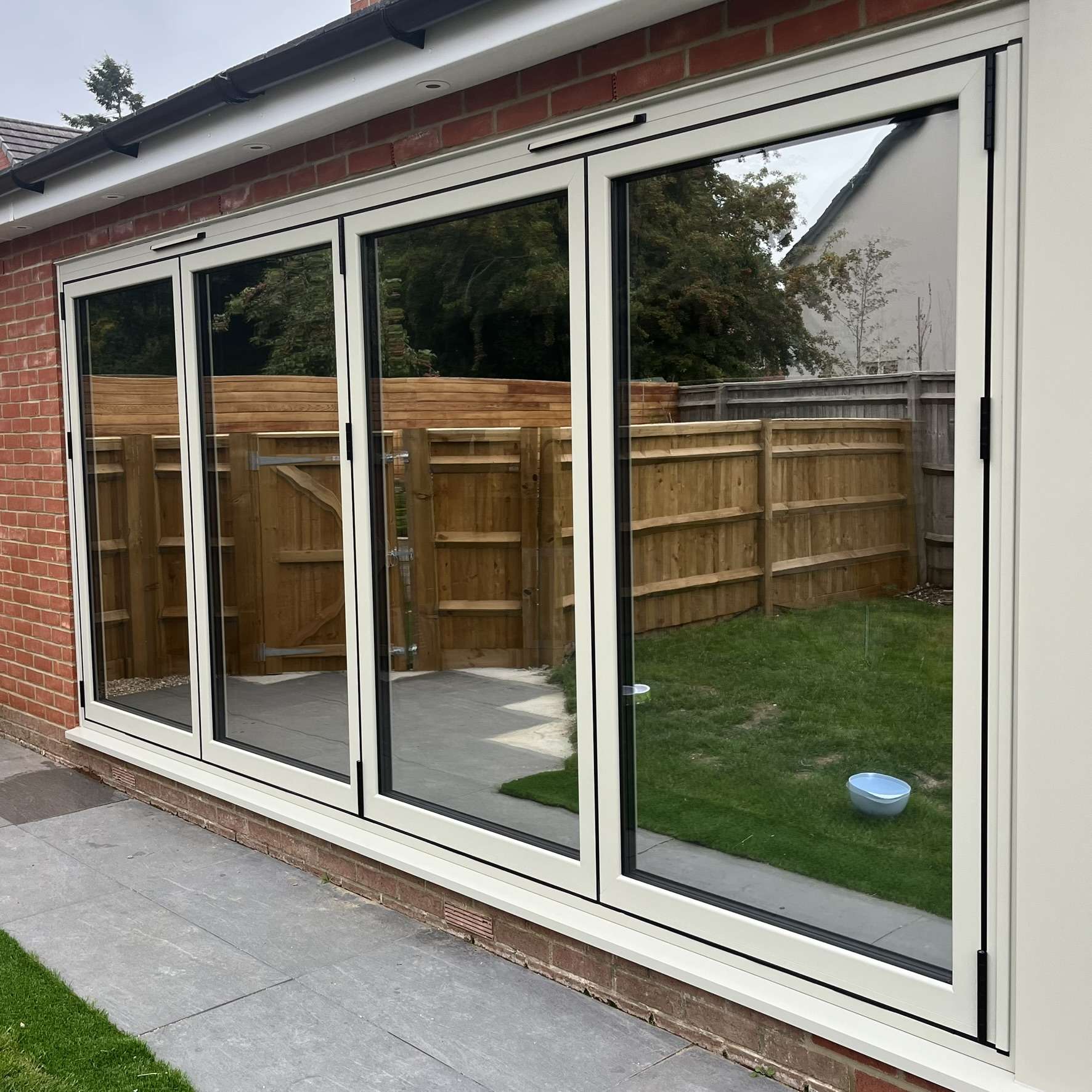 External view of bifold doors in Reading fitted with Silver 20 reflective solar window film, providing daytime privacy and UV protection.