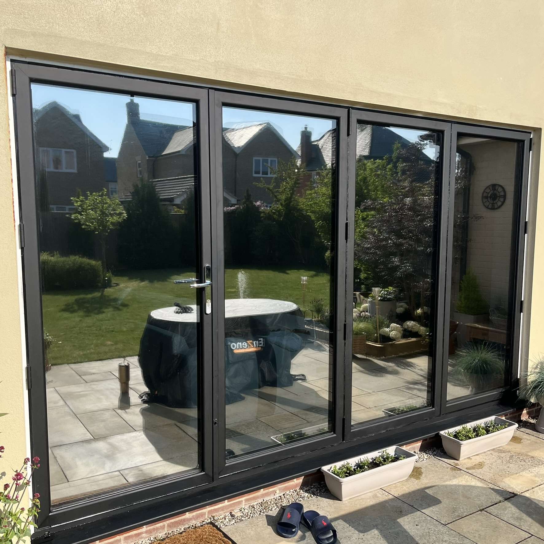 External view of bifold doors in Rochester fitted with Silver 20 reflective solar window film, helping reduce heat, glare, and UV exposure.