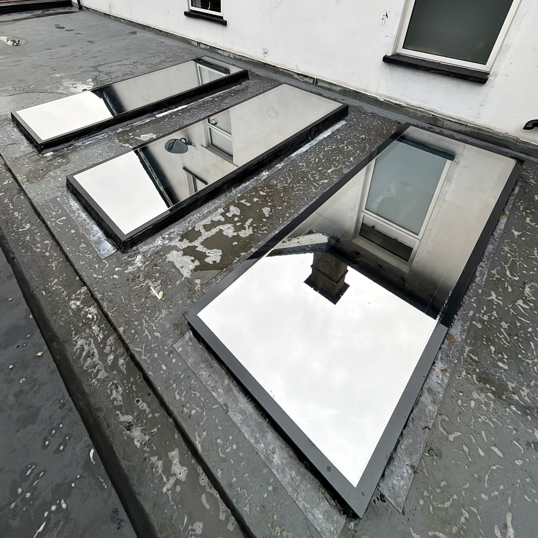 External view of three skylights in Ruislip fitted with external Silver 20 reflective solar window film, providing year-round solar control.