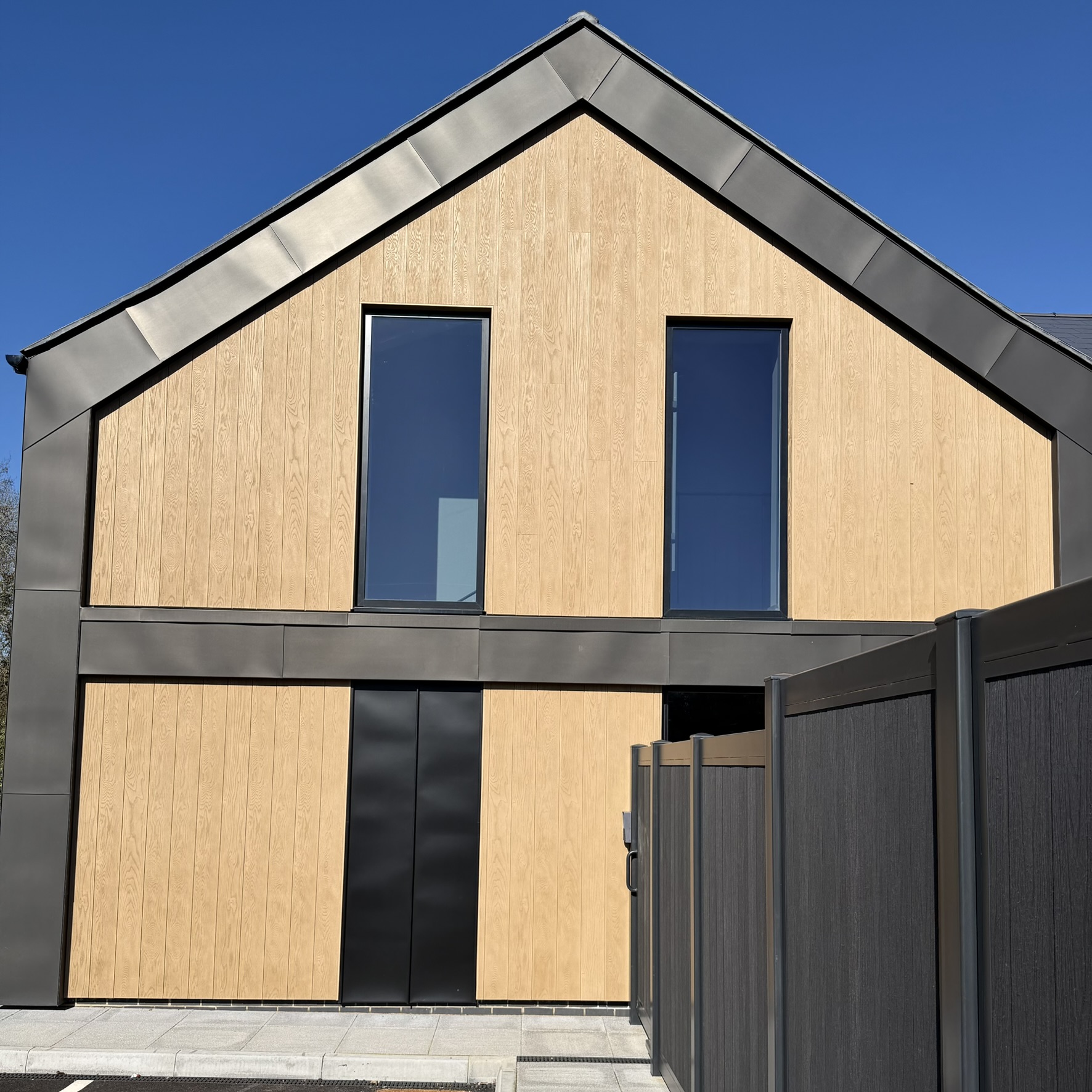 External side view of an office complex in Sevenoaks fitted with Slate 35 tinted solar window film, improving comfort inside the building with glare reduction and heat control.