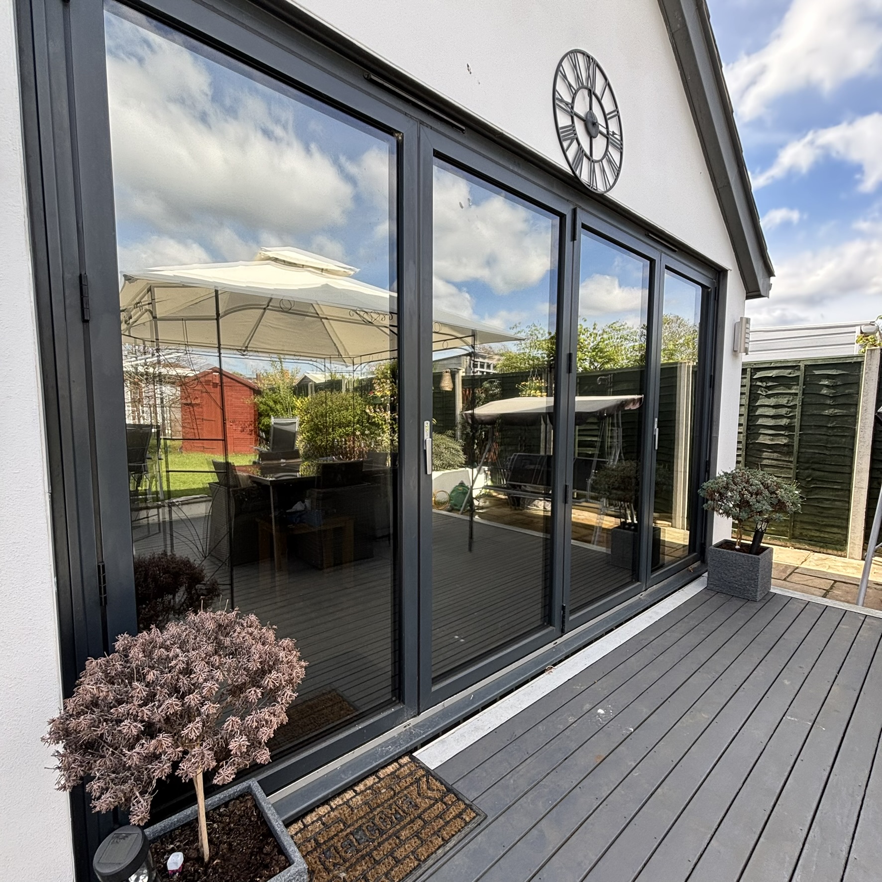 External view of bifold doors in Dartford fitted with Cool Grey 20 solar window film, creating a premium low-mirrored appearance while providing year-round solar control.