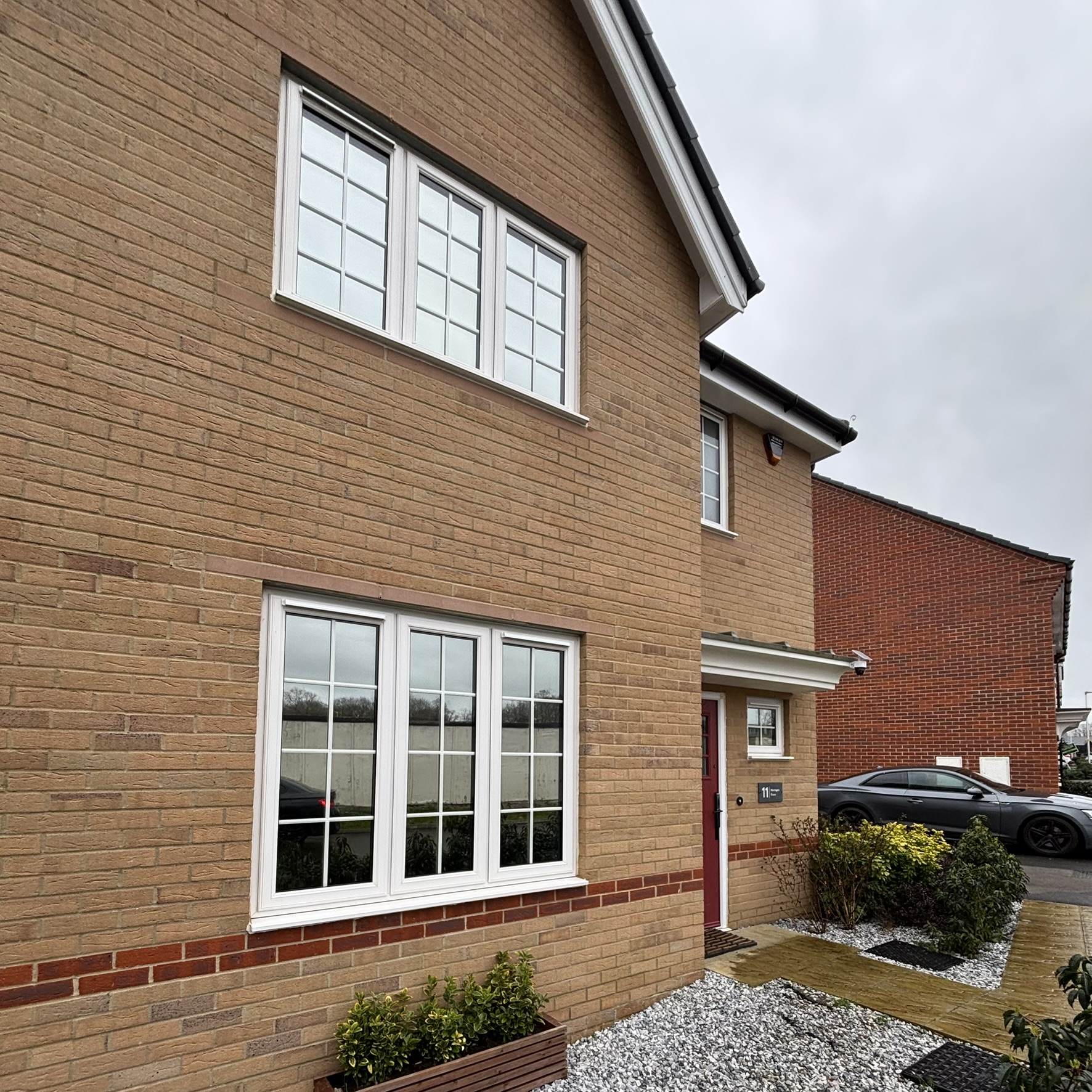 External front view of a residential property in Arborfield Green fitted with Silver 20 reflective solar window film, providing privacy from passers-by with year-round heat and UV control.