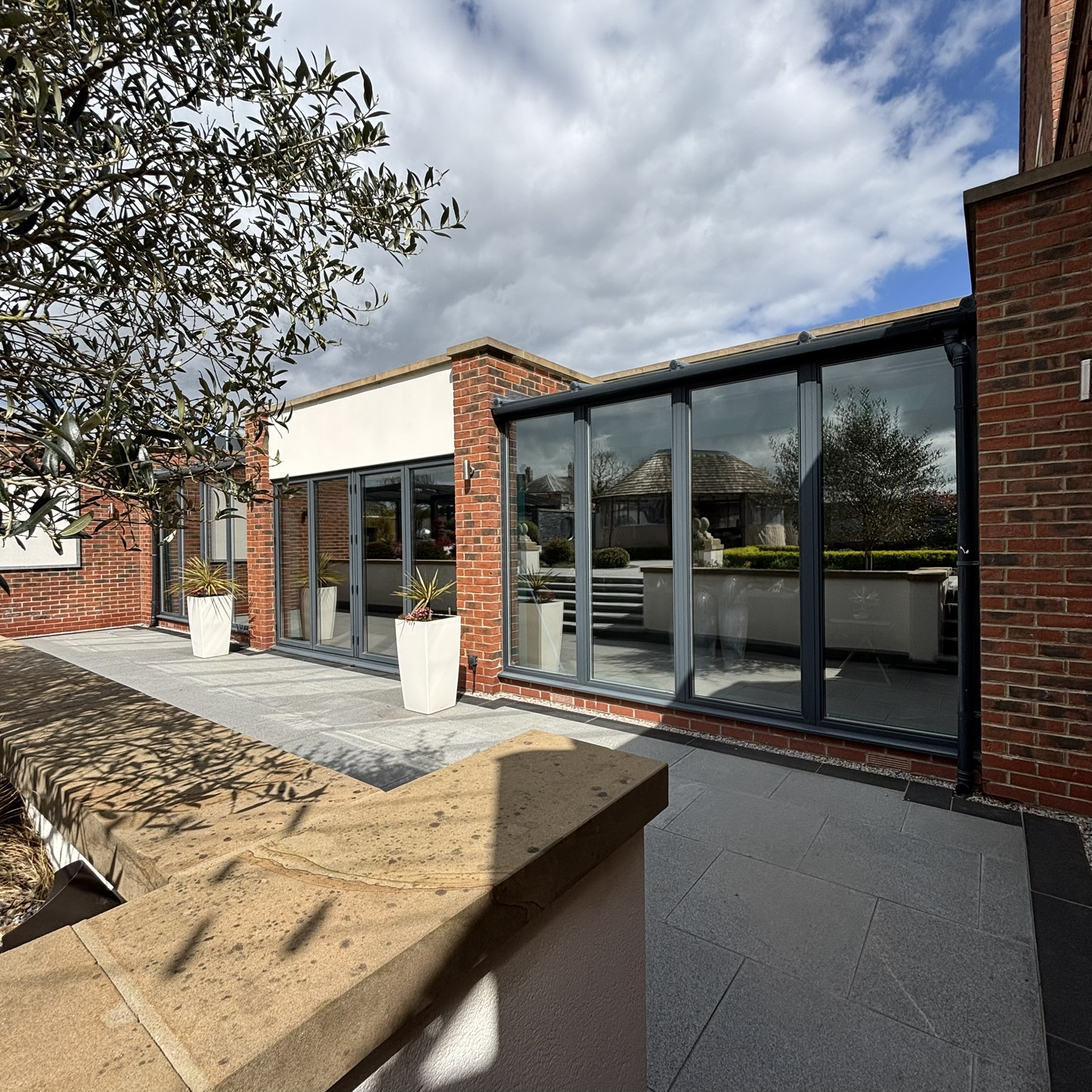 External angle of large doors and bifold doors on a Louth property fitted with Silver 35 reflective solar window film, complementing the modern design and supporting energy efficiency.