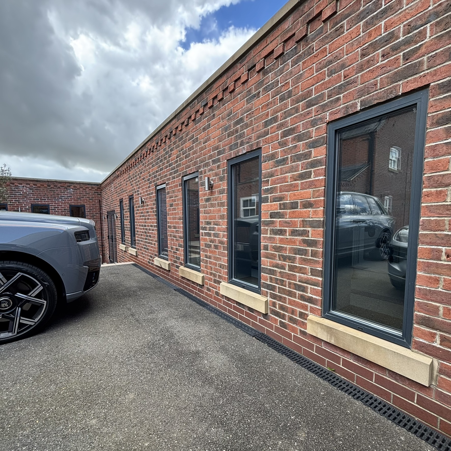 External side view of a Louth property with multiple windows fitted with Silver 35 reflective solar window film, enhancing the architectural appearance and supporting energy efficiency.